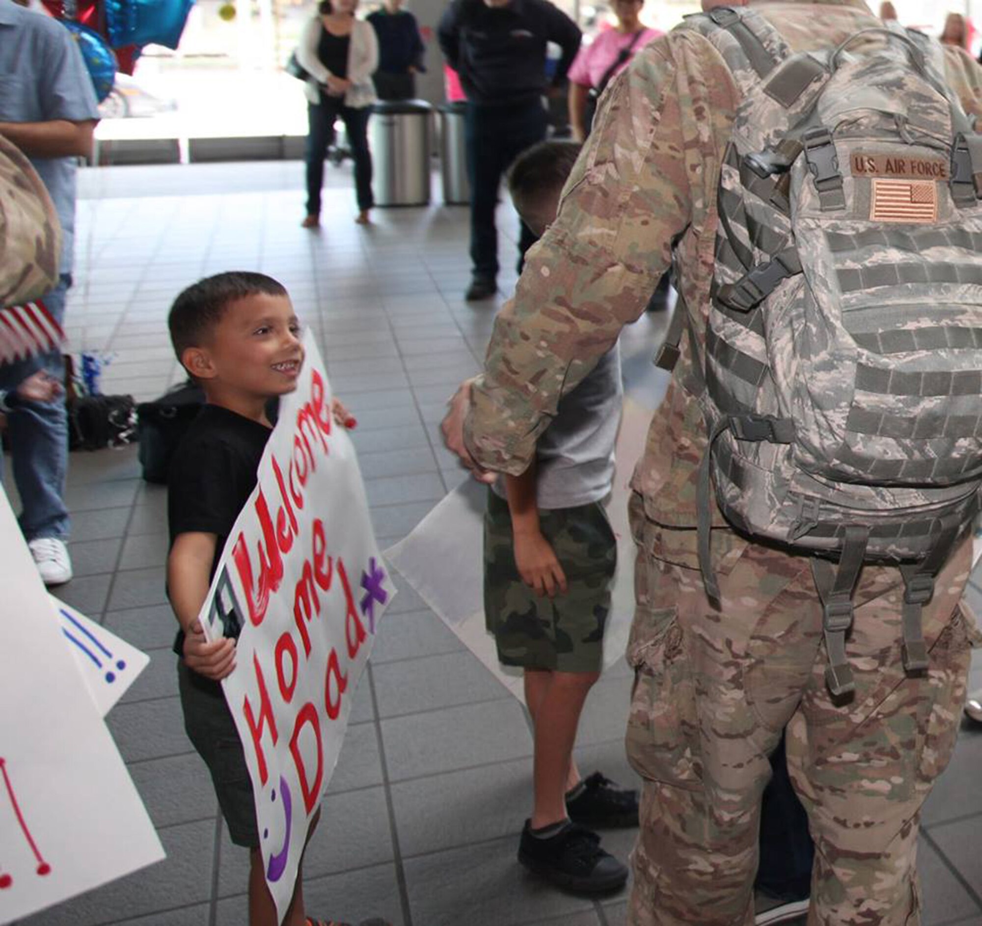 TRAVIS AIR FORCE BASE, Calif. -- Family and friends greet Defenders from the 349th Security Forces Squadron returning from Southwest Asia at Sacramento International Airport, Calif., Oct. 29, 2014. (U.S. Air Force photo/Lt. Col. Robert Couse-Baker) 