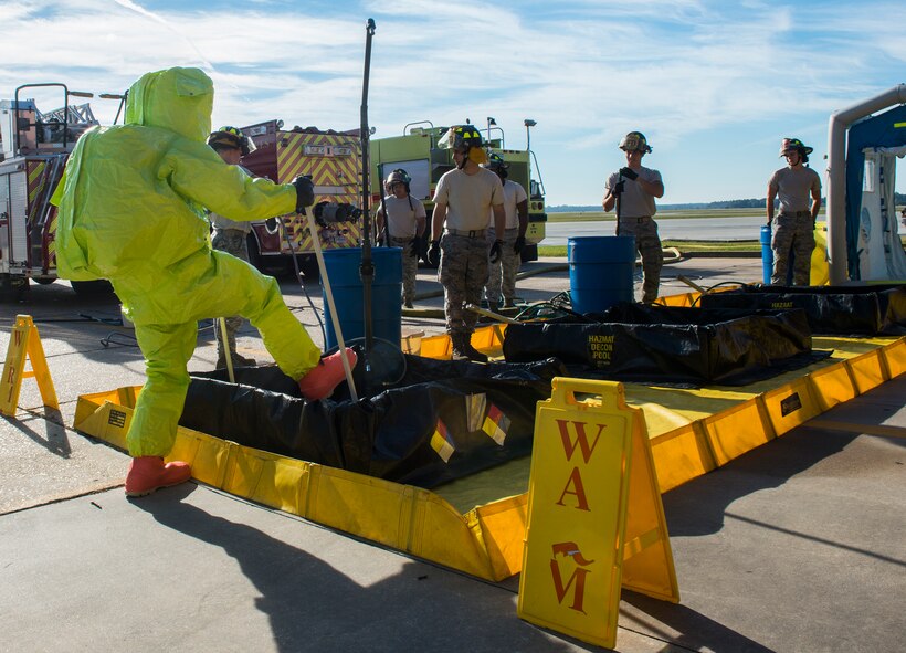 U.S. Air Force Senior Airman Benjamin Jacobson, 23d Civil Engineer Squadron operator, enters a simulated hazardous material decontamination line Oct. 29, 2014, at Moody Air Force Base, Ga. Firefighters of the 23d CES, sectioned the area into three safety zones and labeled them: hot, warm and cold.  The hot zone indentified extreme danger that could be deadly, the warm zone signaled only necessary personnel allowed within and the cold zone represented a completely safe zone where chemicals won’t harm anyone.(U.S. Air Force photo by Airman 1st Class Ceaira Tinsley/Released)