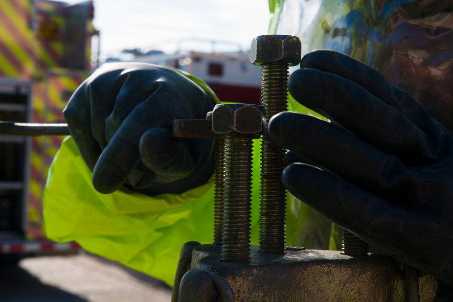 U.S. Air Force Senior Airman Benjamin Jacobson, 23d Civil Engineer Squadron operator, tightens bolts on a chlorine level A kit during hazardous material training Oct. 29, 2014 at Moody Air Force Base, Ga. Firefighters of the 23d CES trained to create fast reaction times in case of a real world emergency. (U.S. Air Force photo by Airman 1st Class Ceaira Tinsley/Released)