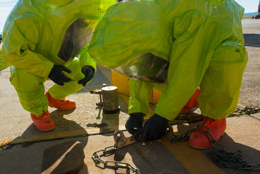 U.S. Air Force Senior Airman Benjamin Jacobson, 23d Civil Engineer Squadron operator and Ryan Miller, 23d CES firefighter, work on a chlorine level A kit to secure a spill during hazardous material training Oct. 29, 2014, at Moody Air Force Base, Ga. Firefighters of the 23d CES trained for a simulated chlorine spill because it is a common hazardous chemical. (U.S. Air Force photo by Airman 1st Class Ceaira Tinsley/Released)