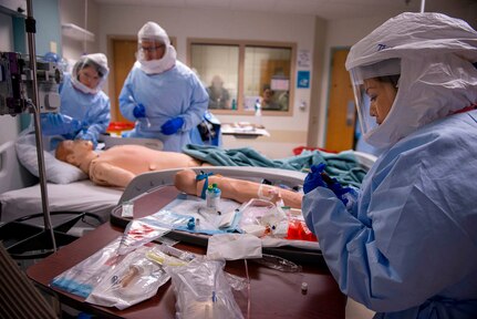 U.S. Air Force Capt. Tanya Tsosie draws blood from a simulated Ebola patient during the week-long training course at the San Antonio Military Medical Center. Tsosie, a nurse from the 959th Medical Group, is assigned to a 30-member medical response team designed to support civilian medical professionals in the event of an Ebola outbreak in the United States. (U.S. Air Force photo/Master Sgt. Jeffrey Allen)