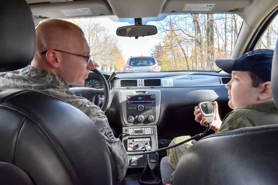 U.S. Air Force Reserve Senior Airman Justin Kelly, a 910th Security Forces Squadron member, instructs 11-year-old Jacob Sypert on how to make radio calls for a routine traffic stop here, Oct. 29, 2014. Sypert became the 910th Airlift Wing’s 60th Pilot for a Day, being sworn in as an honorary second lieutenant and spending the day here experiencing military activities including a high-speed taxi down the runway in a Youngstown C-130H Hercules aircraft. The Pilot for a Day program began in 2000 as a community outreach event for the purpose of providing a fun-filled day for children with life-threatening or chronic illnesses. U.S. Air Force photo/Eric M. White