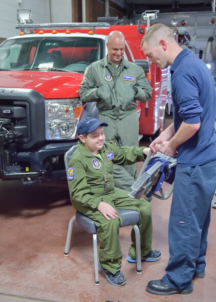 Tim Wertz, a firefighter with the 910th Civil Engineer Fire Department, shows a jaws of life unit to 11-year-old Jacob Sypert here, Oct. 29, 2014. Sypert became the 910th Airlift Wing’s 60th Pilot for a Day, being sworn in as an honorary second lieutenant and spending the day here experiencing military activities including a high-speed taxi down the runway in a Youngstown C-130H Hercules aircraft. The Pilot for a Day program began in 2000 as a community outreach event for the purpose of providing a fun-filled day for children with life-threatening or chronic illnesses. U.S. Air Force photo/Eric M. White