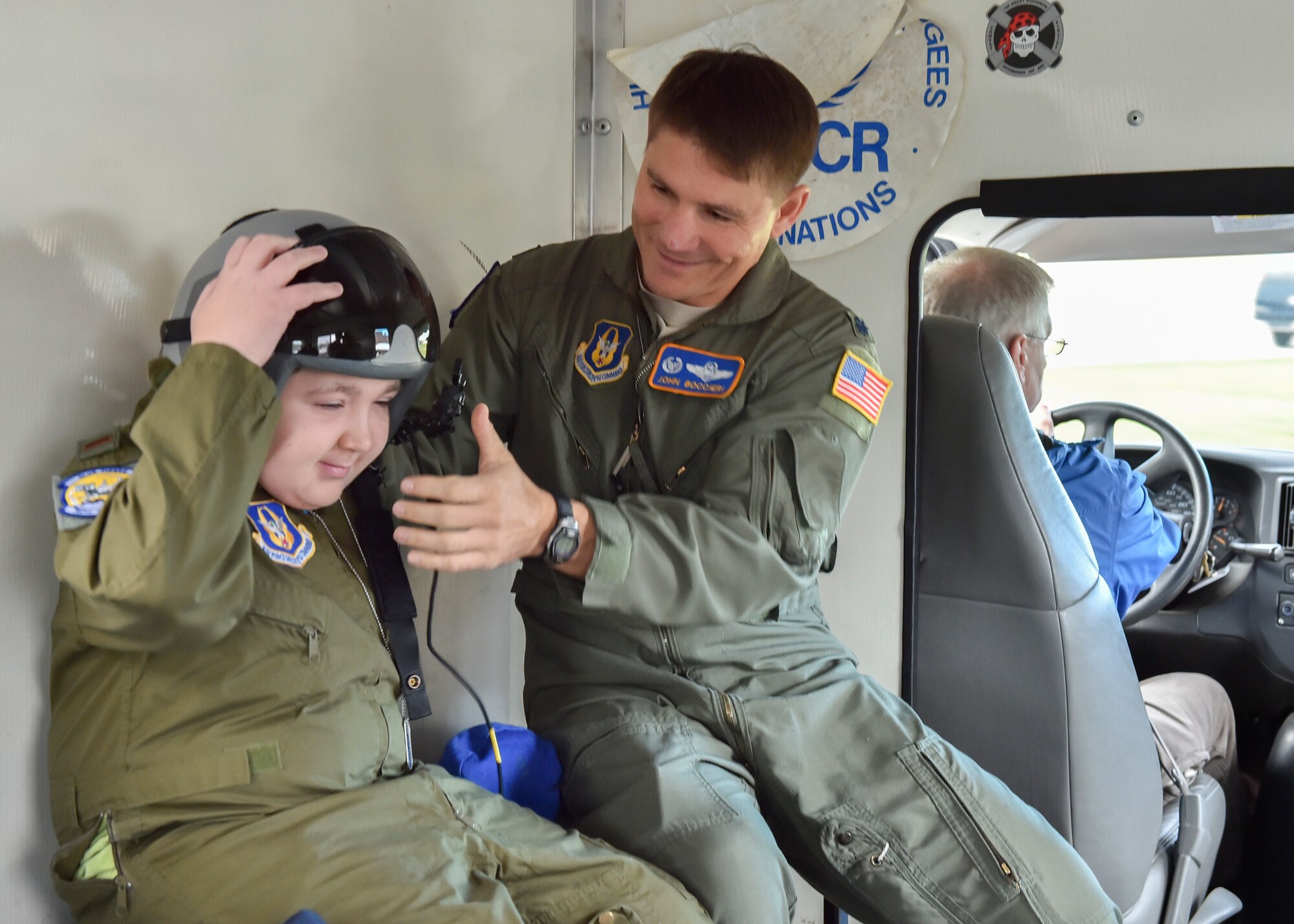 Lt. Col. John Boccieri, 757th Airlift Squadron commander, helps 11-year-old Jacob Sypert try on a flight helmet here Oct. 29, 2014. Sypert became the 910th Airlift Wing’s 60th Pilot for a Day, being sworn in as an honorary second lieutenant and spending the day here experiencing military activities including a high-speed taxi down the runway in a Youngstown C-130H Hercules aircraft. The Pilot for a Day program began in 2000 as a community outreach event for the purpose of providing a fun-filled day for children with life-threatening or chronic illnesses. U.S. Air Force photo/Eric M. White