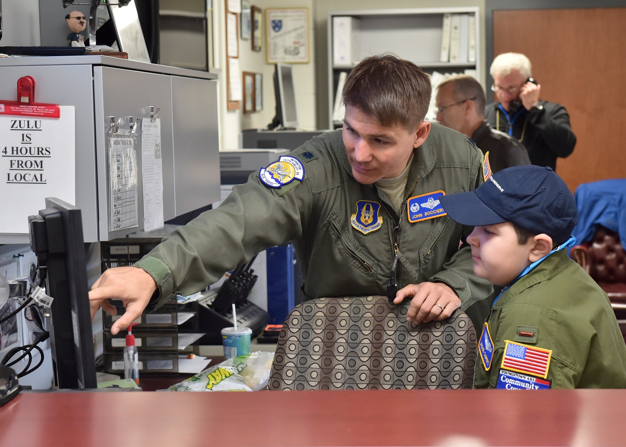 Lt. Col. John Boccieri, 757th Airlift Squadron commander, shows a weather map to 11-year-old Jacob Sypert here Oct. 29, 2014. Sypert became the 910th Airlift Wing’s 60th Pilot for a Day, being sworn in as an honorary second lieutenant and spending the day here experiencing military activities including a high-speed taxi down the runway in a Youngstown C-130H Hercules aircraft. The Pilot for a Day program began in 2000 as a community outreach event for the purpose of providing a fun-filled day for children with life-threatening or chronic illnesses. U.S. Air Force photo/Eric M. White