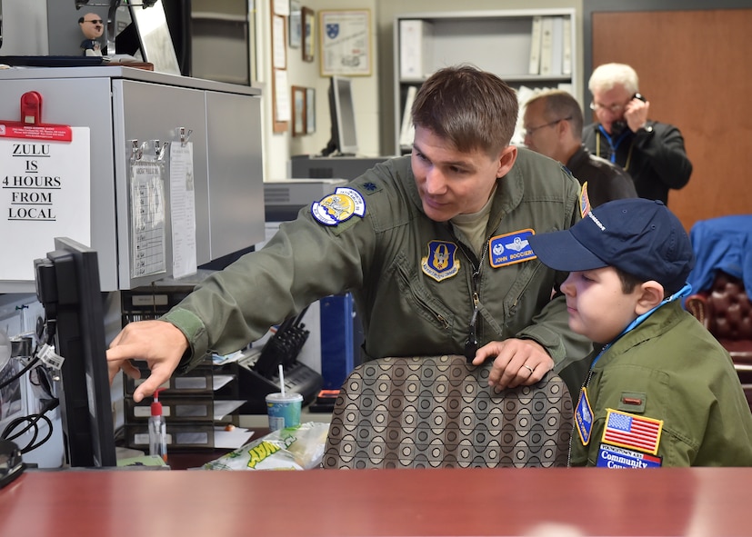 Lt. Col. John Boccieri, 757th Airlift Squadron commander, shows a weather map to 11-year-old Jacob Sypert here Oct. 29, 2014. Sypert became the 910th Airlift Wing’s 60th Pilot for a Day, being sworn in as an honorary second lieutenant and spending the day here experiencing military activities including a high-speed taxi down the runway in a Youngstown C-130H Hercules aircraft. The Pilot for a Day program began in 2000 as a community outreach event for the purpose of providing a fun-filled day for children with life-threatening or chronic illnesses. U.S. Air Force photo/Eric M. White