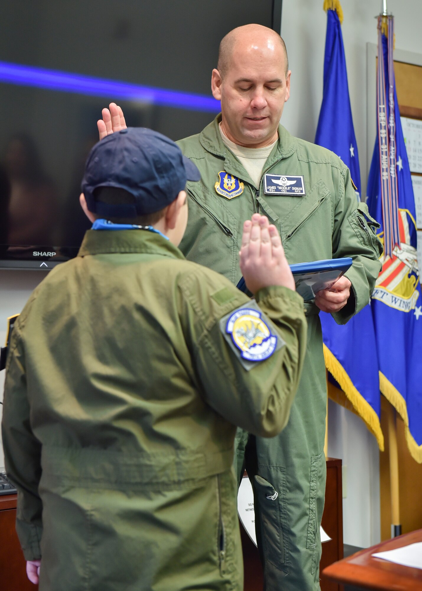 U.S. Air Force Reserve Col. James Dignan, 910th Airlift Wing commander, administers the oath of office to 11-year-old Jacob Sypert here, Oct. 29, 2014. Sypert became the 910th Airlift Wing’s 60th Pilot for a Day, being sworn in as an honorary second lieutenant and spending the day here experiencing military activities including a high-speed taxi down the runway in a Youngstown C-130H Hercules aircraft. The Pilot for a Day program began in 2000 as a community outreach event for the purpose of providing a fun-filled day for children with life-threatening or chronic illnesses. U.S. Air Force photo/Eric M. White