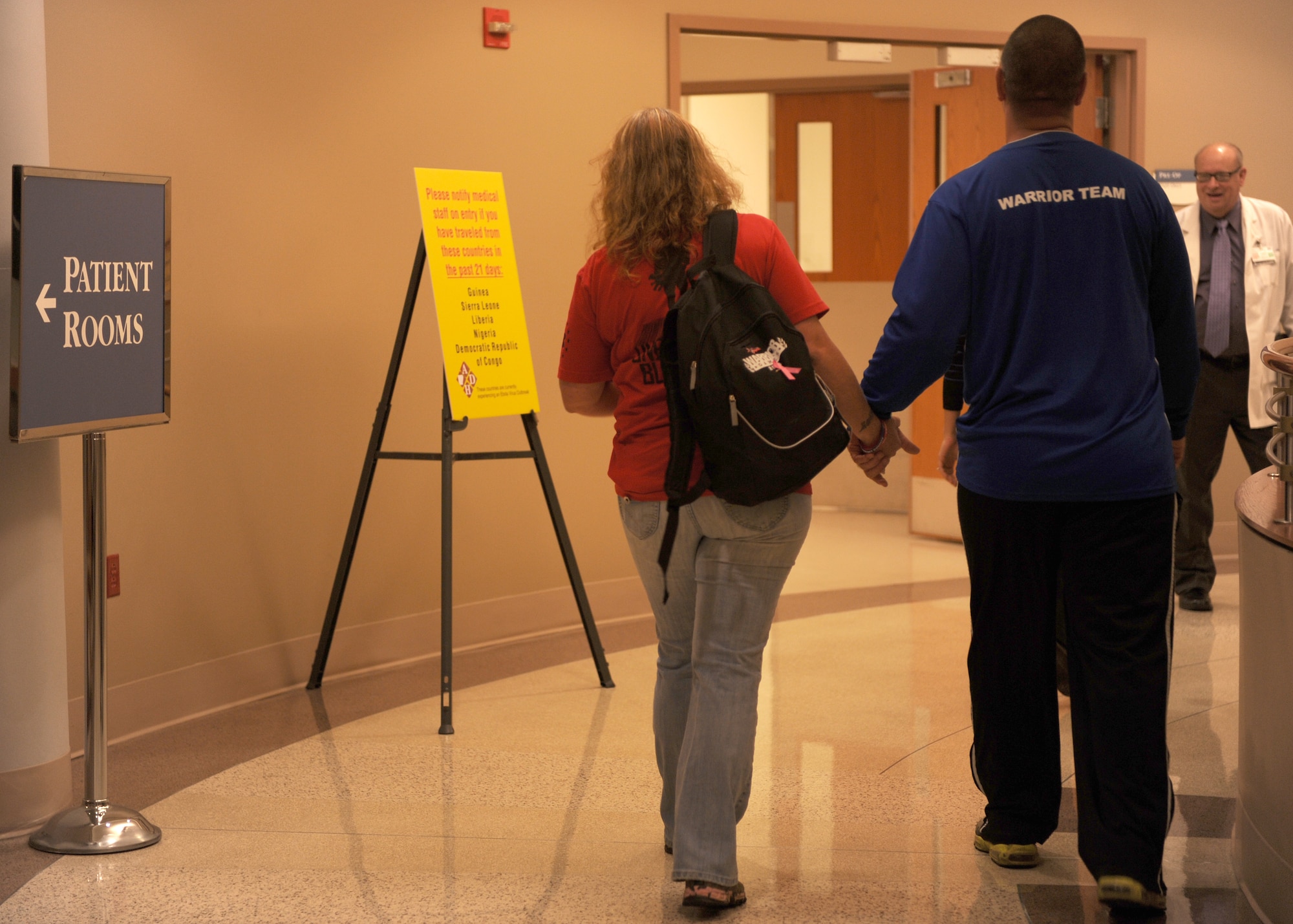 Tech. Sgt. Jason Caswell, a 19th Aircraft Maintenance Squadron crew chief, along with his wife, Tami, walk hand-in-hand to the preparation room for his operation Oct. 17, 2014, at Baptist Health Medical Center, Little Rock, Ark. After four years and eight surgeries, Caswell decided to get his leg amputated in his, hopefully, final attempt to improve his quality of life. (U.S. Air Force photo by Airman 1st Class Scott Poe)
