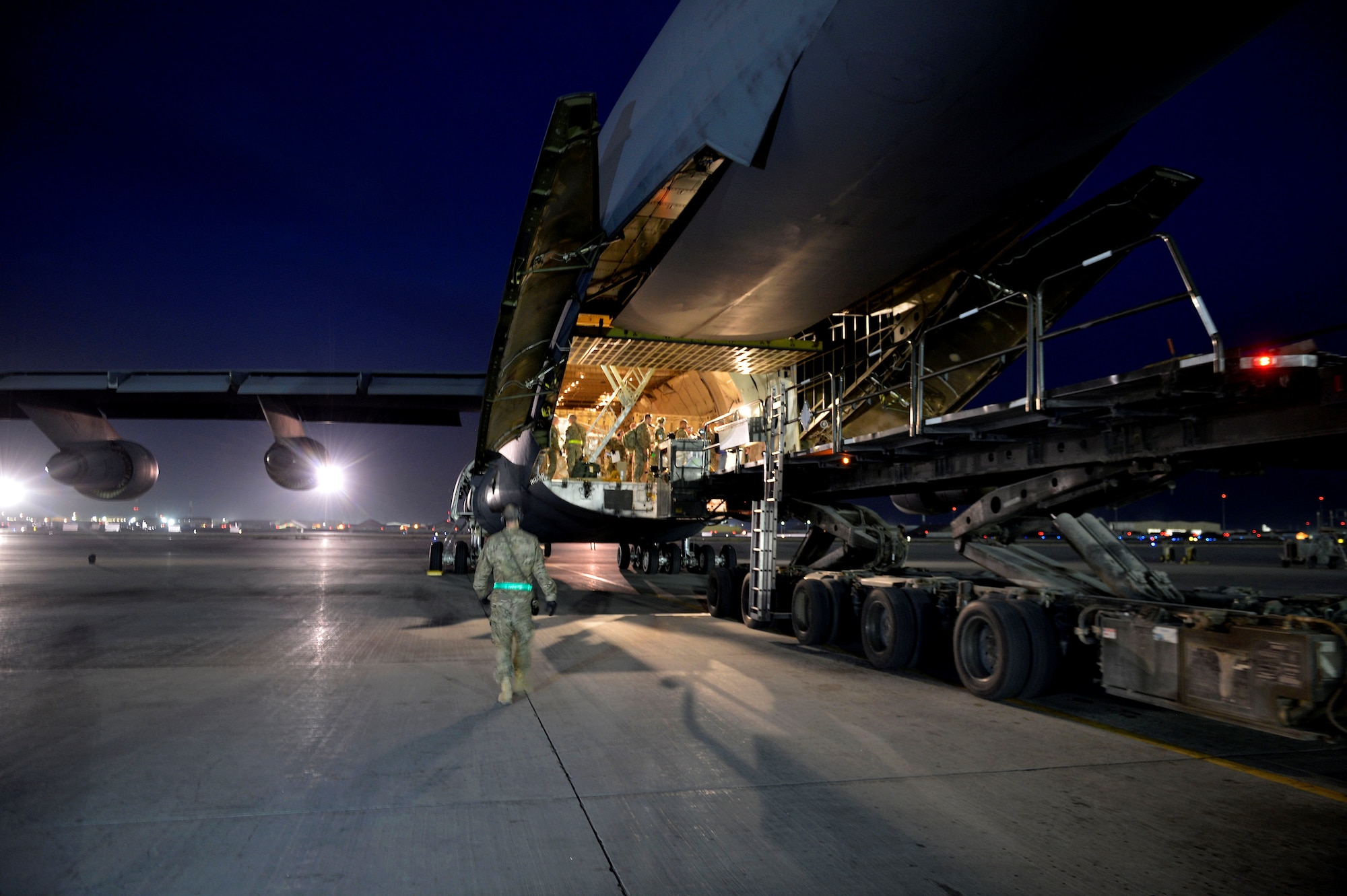 U.S. Air Force Airmen with the 455th Expeditionary Aerial Port Squadron load cargo into a C-17 Globemaster III loadmaster Sept. 9, 2014. Airmen assigned to the 455 EAPS have serviced more than 14,300 missions and 114,700 short tons of cargo since the beginning of the year to support Operation Enduring Freedom. (U.S. Air Force photo by Staff Sgt. Evelyn Chavez/Released)