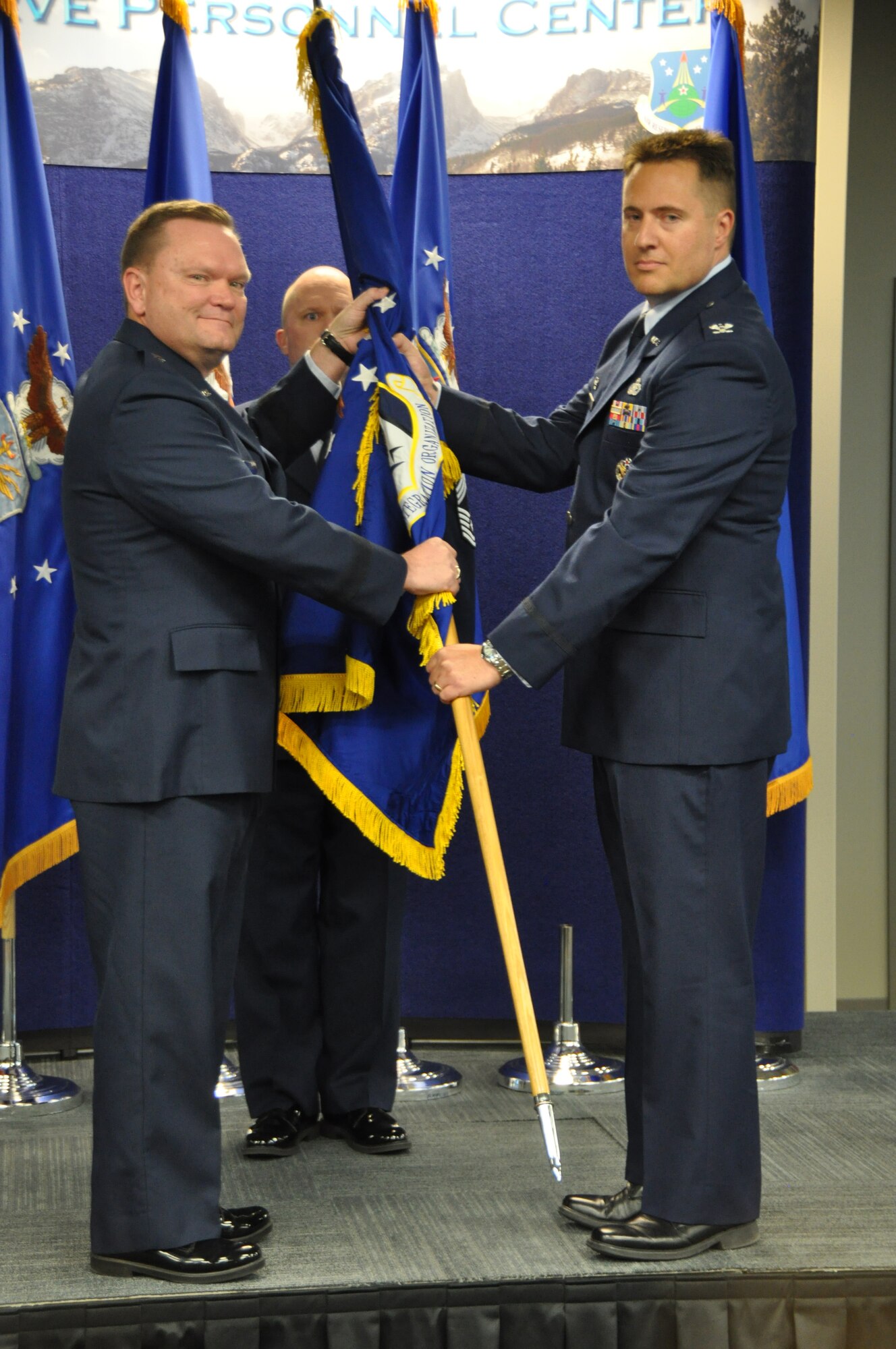 Brig. Gen. Samuel C. Mahaney, Headquarters Air Reserve Personnel Center commander, presents command of Headquarters RIO to Col. Christopher E. Cronce during a ceremonial activation, held Oct. 28 at ARPC. (U.S. Air Force photo/MSgt. Richard Grybos)