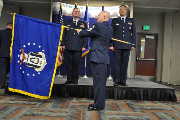 Chief Master Sgt. Seth Perron unfurls the new Headquarters RIO flag during a ceremonial activation, held Oct. 28 at Headquarters Air Reserve Personnel Center. The ceremony was presided over by Brig. Gen. Samuel C. Mahaney, ARPC commander, and Col. Christopher E. Cronce assumed command of the new organization. (U.S. Air Force photo/MSgt. Richard Grybos) 