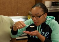 Airman 1st Class Seydonia Baker, 436th Aerial Port Squadron ramp specialist, tastes a small sample of broth during a “Dorm to Gourm” Leadership Pathways Professional Development course Oct. 28, 2014, at the fitness center on Dover Air Force Base, Del. Baker was one of several Team Dover Airmen to attend the class. (U.S. Air Force photo/Airman 1st Class Zachary Cacicia)