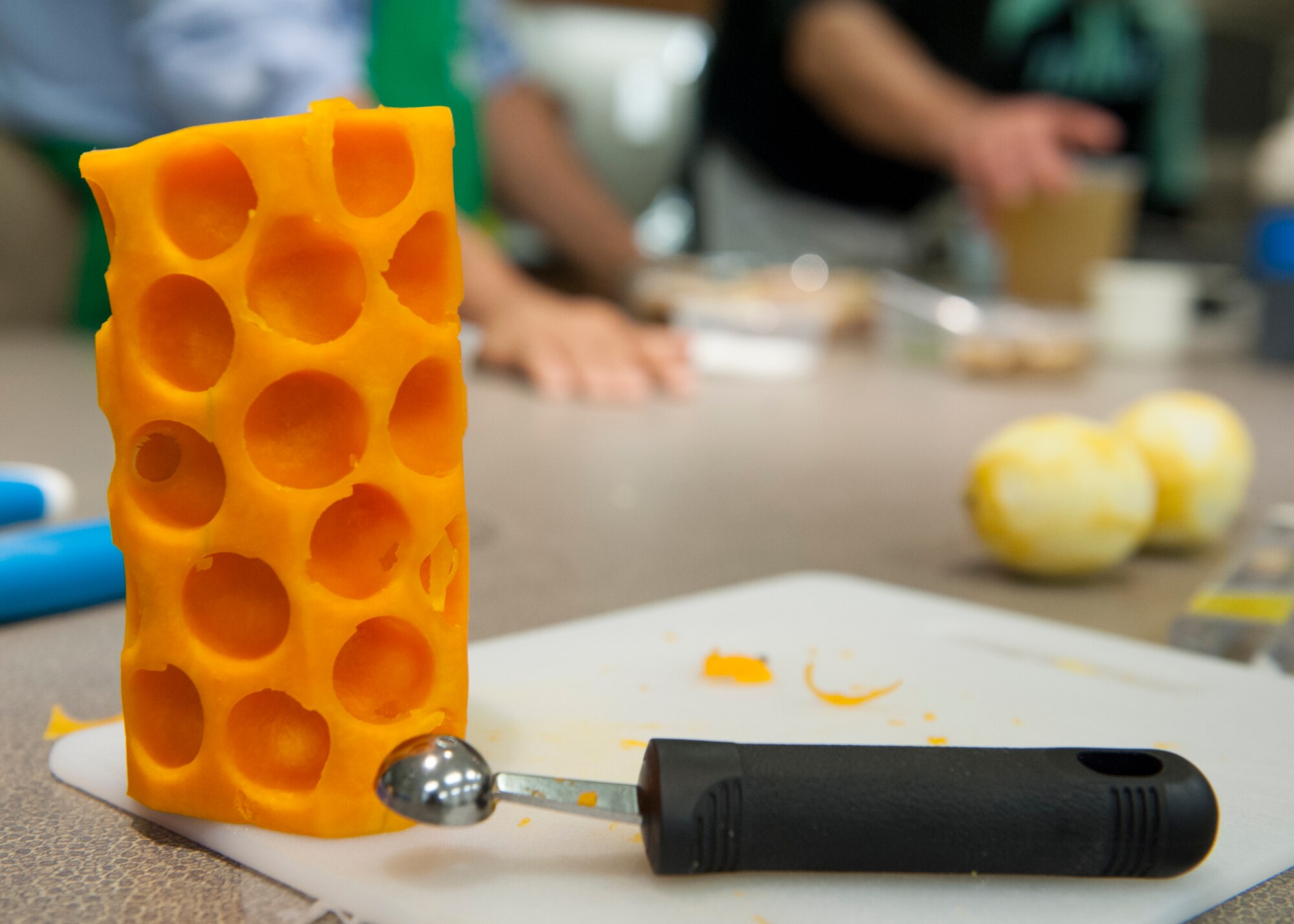 The remnants of a butternut squash sit on a cutting board during a “Dorm to Gourm” Leadership Pathways Professional Development course Oct. 28, 2014, at the fitness center on Dover Air Force Base, Del.  Small ball-shaped chunks were cut out of the squash by Staff Sgt. Nicole Hawley, 436th Mission Support Group executive support staff, to be used in the dish. (U.S. Air Force photo/Airman 1st Class Zachary Cacicia)