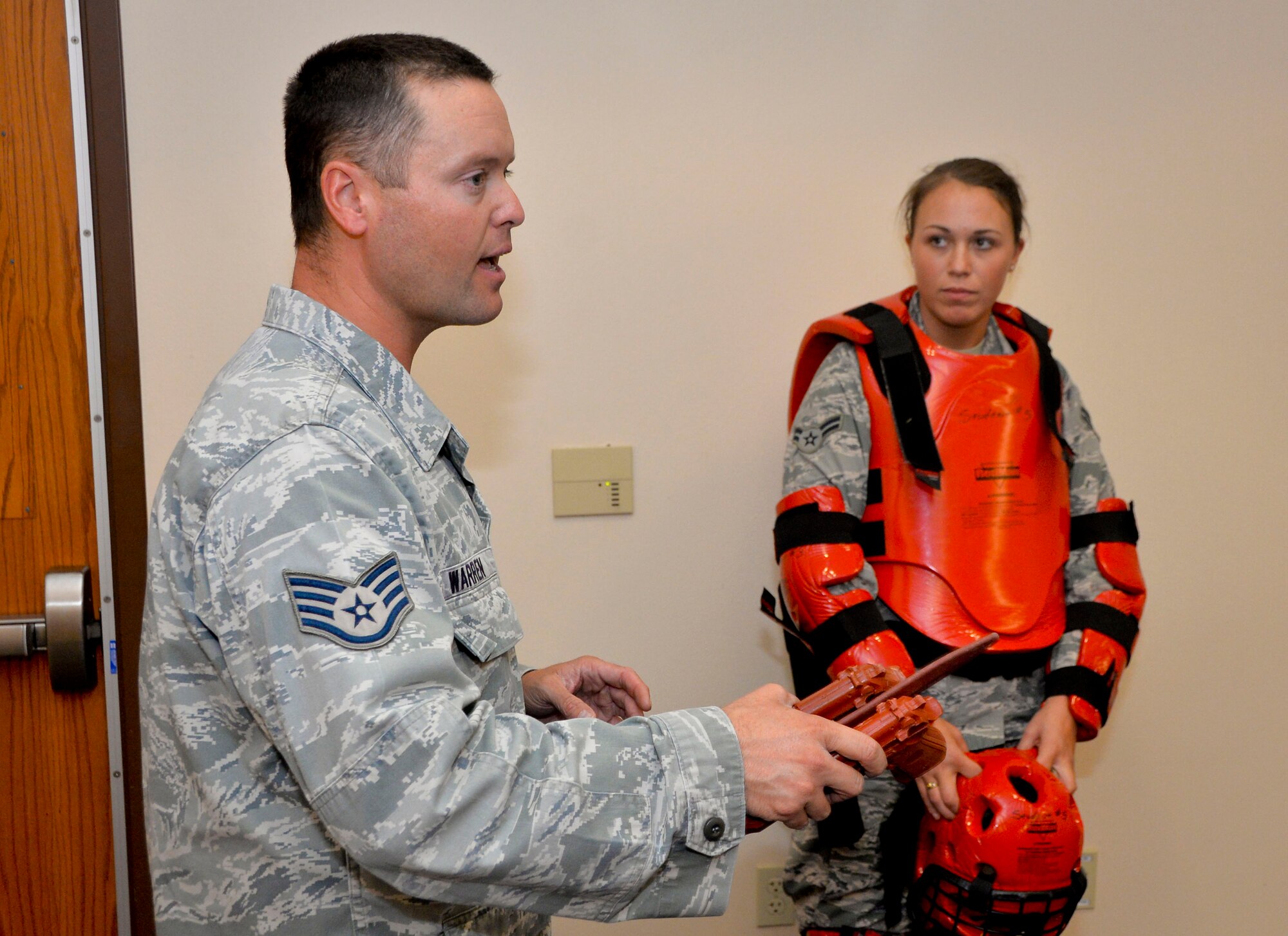 Staff Sgt. Donnie Warren, 2nd Security Forces Squadron training instructor, and Airman 1st Class Emily Jacques, 2nd SFS installation entry controller, review a training scenario on Barksdale Air Force Base, La., Oct. 27, 2014. Scenario training helps Airmen practice effective use of force based on the actions a suspect takes during a confrontation. (U.S. Air Force photo/Airman 1st Class Mozer O. Da Cunha)