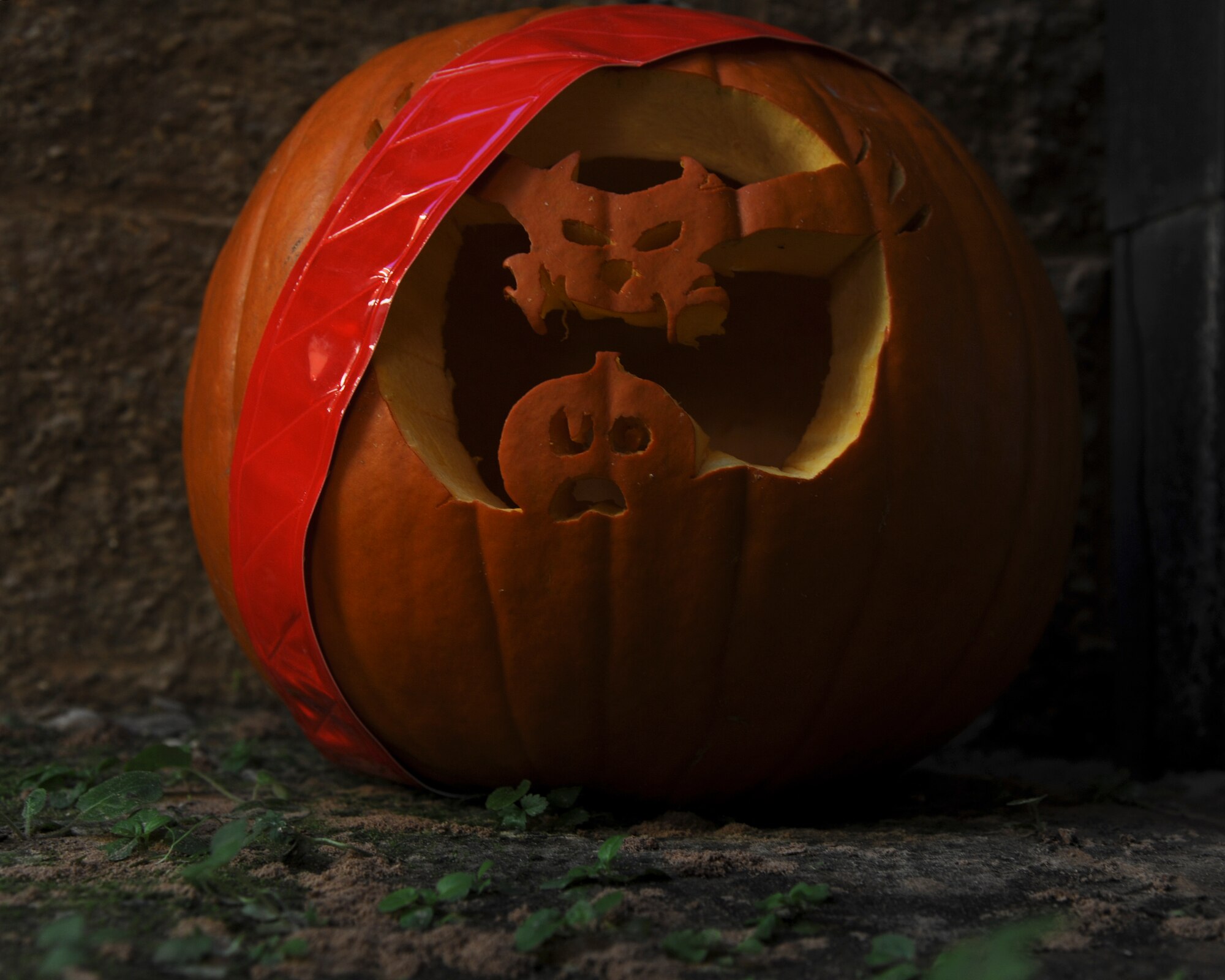 A reflective belt is wrapped around a jack-o-lantern to represent Halloween safety. Trick-or-treating hours for Barksdale will be Oct. 31 5:30 to 7:30 p.m.; the Pumpkin Patrol will be ensuring the safety of children around the base by being present throughout base housing. (U.S. Air Force photo/Senior Airman Jannelle Dickey)