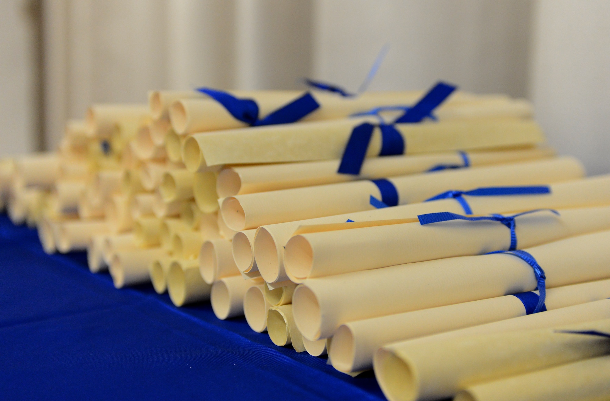 Community College of the Air Force diplomas lay on a table at the base theater on Spangdahlem Air Force, Germany, Oct. 29, 2014. The diplomas were handed to the graduating Airmen by U.S. Air Force Col. Pete Bilodeau, 52nd Fighter Wing commander, and Chief Master Sgt. Brian Gates, 52nd FW command chief. (U.S. Air Force photo by Airman 1st Class Luke Kitterman/Released) 