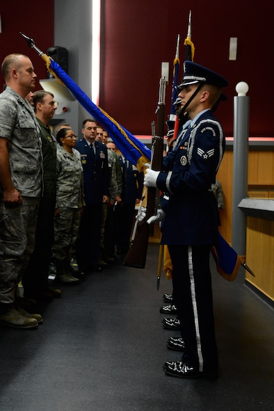 Spangdahlem Air Base Honor Guard members post the colors during a Community College of the Air Force graduation at the base theater on Spangdahlem Air Base, Germany, Oct. 29, 2014. Both the German and American national anthems were sung during the posting of the colors to initiate the ceremony. (U.S. Air Force photo by Airman 1st Class Luke Kitterman/Released)