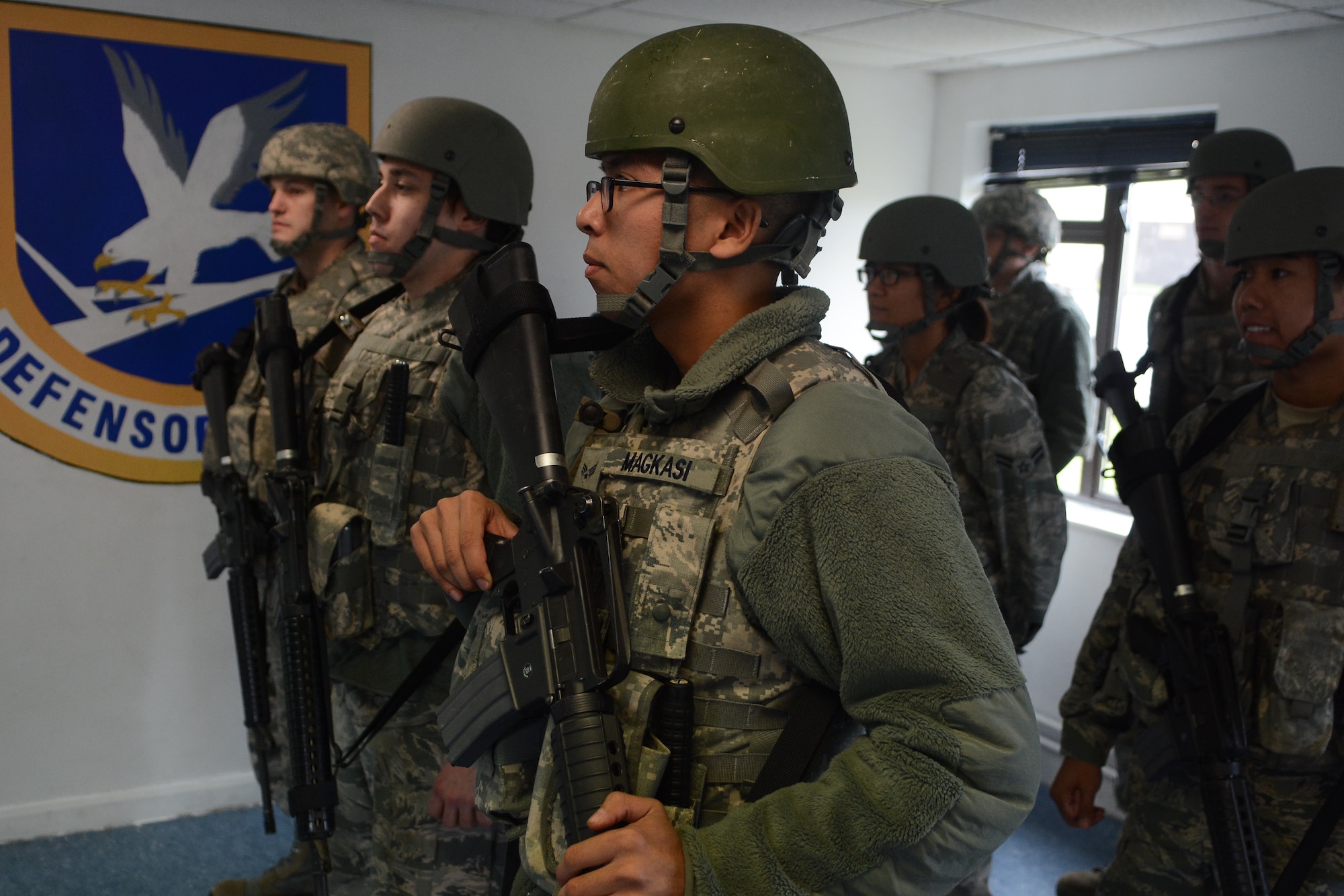 U.S. Air Force security forces augmentees receive a guardmount briefing during an exercise Oct. 8, 2014, on RAF Mildenhall, England. After the briefing, augmentees were paired with 100th Security Forces Airmen to help keep the base safe and secure. (U.S. Air Force photo by Staff Sgt. Micaiah Anthony/Released)