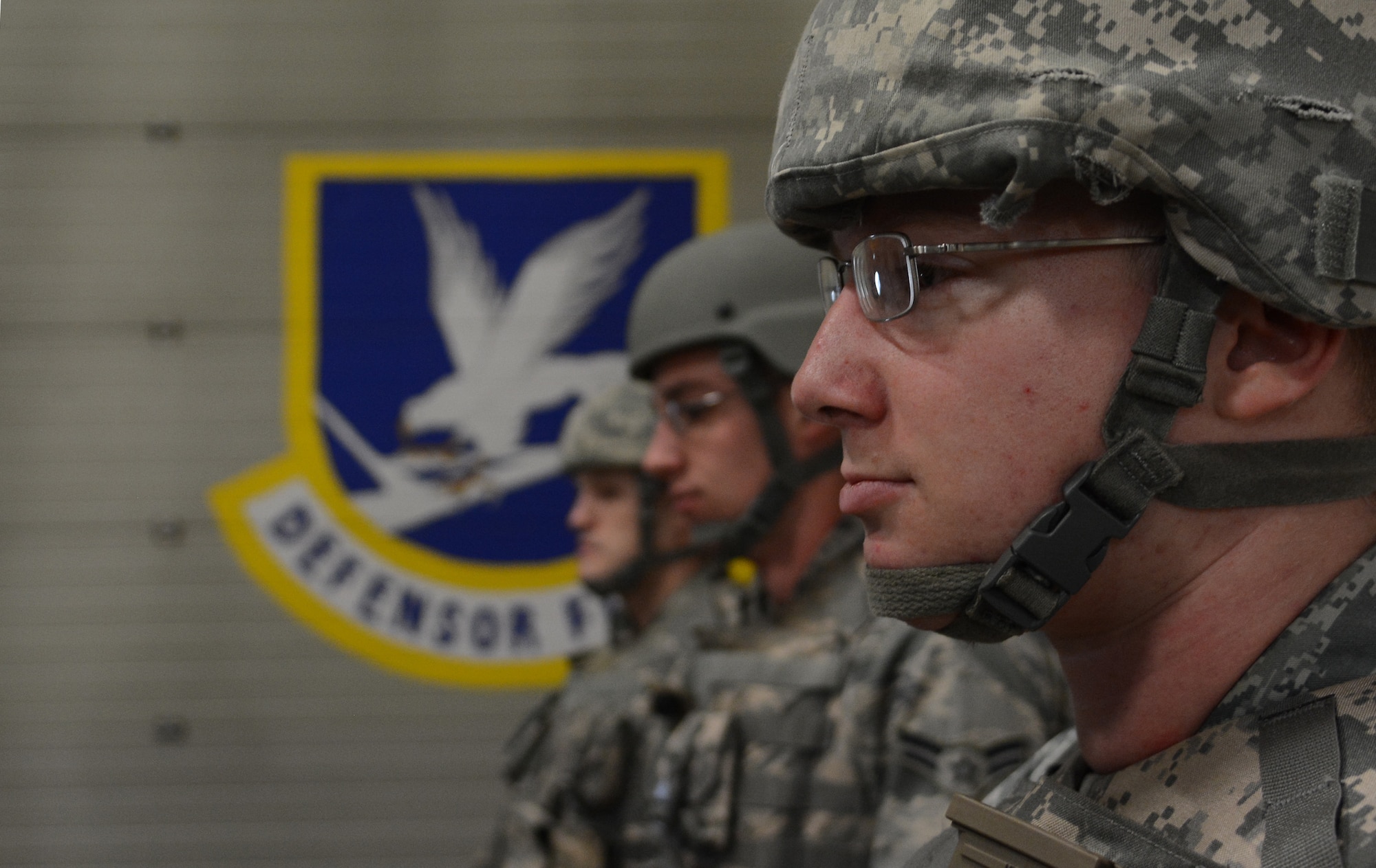 U.S. Air Force Senior Airman Kyle Johansen, right, 100th Communication Squadron cyber systems journeyman, from Hockinson, Wash., waits for instructions after donning his gear during an exercise Oct. 8, 2014, on RAF Mildenhall, England. Augmentees were issued protective body armor and M16 assault rifles so they could perform basic military police duties. (U.S. Air Force photo by Staff Sgt. Micaiah Anthony/Released)