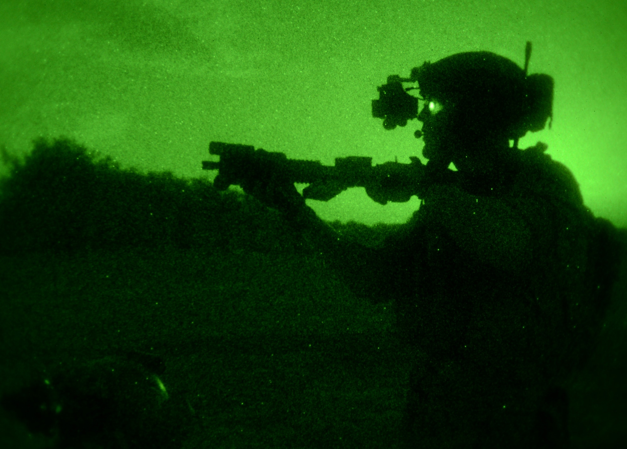 A U.S. Air Force Air Commando aims his weapon to designate a target Oct. 9, 2014, during a training mission at Stanford Training Area near Thetford, England. Air Commandos can use the infrared lasers attached to their weapons to designate targets for other operators equipped with night vision goggles. (U.S. Air Force photo by Airman 1st Class Kyla Gifford/Released)