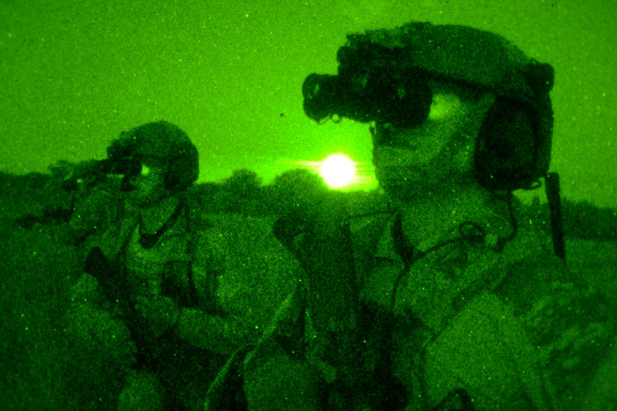 U.S. Air Force Air Commandos use night vision goggles to survey an area Oct. 9, 2014, during a training mission at Stanford Training Area near Thetford, England. During the training mission, Air Commandos searched for simulated potential threats and rescued simulated hostages in the training area. (U.S. Air Force photo by Staff Sgt. Micaiah Anthony/Released)