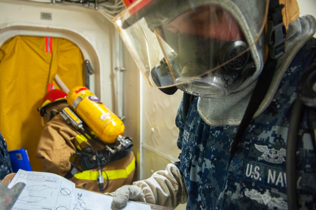 Navy Petty Officer 2nd Class Justin Weide manages the secondary ...