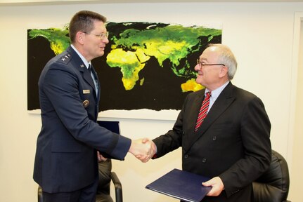 U.S. Air Force Maj. Gen. David D. Thompson, U.S. Strategic Command director of plans and policy, left, and Jean-Jacques Dordain, European Space Agency director general, shake hands after signing a new Space Situational Awareness data-sharing agreement at the ESA office in Washington D.C., Oct. 30, 2014. The agreement provides ESA with more timely and higher quality space information and allows USSTRATCOM to optimize its space capabilities. USSTRATCOM currently holds SSA data-sharing agreements with seven countries and several organizations, advancing the command's mission to build enduring relationships with partners and address challenges in space. (Photo courtesy of ESA)