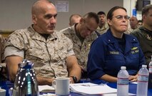 Maj. Gen. Richard L. Simcock, commanding general of 2nd Marine Expeditionary Brigade, and Rear Adm. Cynthia Thebaud, commander of Expeditionary Strike Group 2, receive an update of events aboard the USS Iwo Jima during Exercise Bold Alligator 2014, Oct. 30. Simcock and Thebaud took command of naval forces within 24 hours notice by executing the experimental Fly-In and Integrated Command Element concept aboard the USS Iwo Jima off the coast of North Carolina. The FICE, part of the Marine's Expeditionary Force 21 Concept, is one of many experiments being conducted during Exercise Bold Alligator 2014.