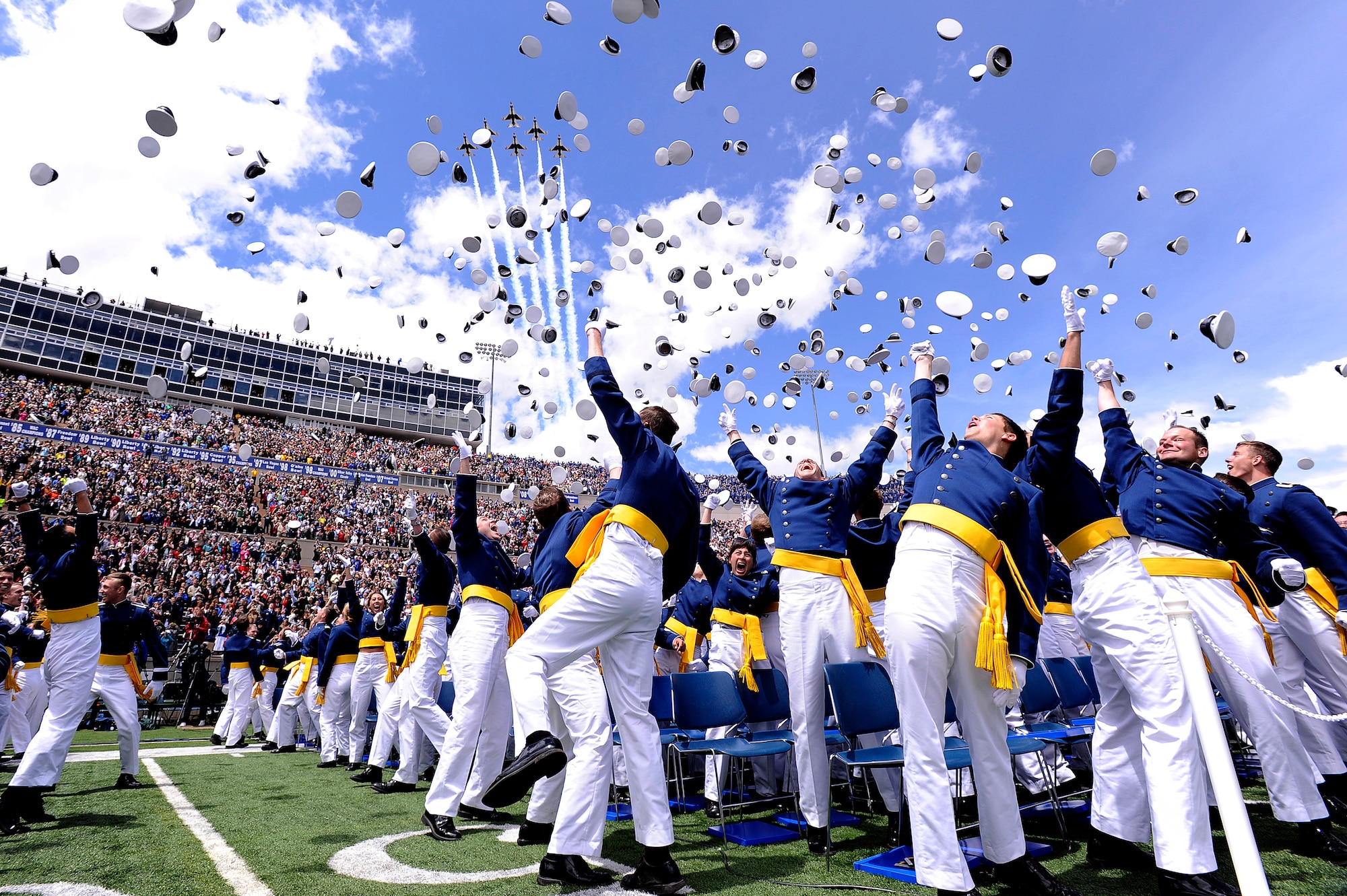 Newly commissioned second lieutenants celebrate at the end of the Air Force Academy's Class of 2011 graduation ceremony May 25, 2011. Flying overhead are F-16 Fighting Falcons with the Thunderbirds. Secretary of the Air Force Michael B. Donley was the guest speaker for the commencement. (U.S. Air Force photo/Mike Kaplan)
