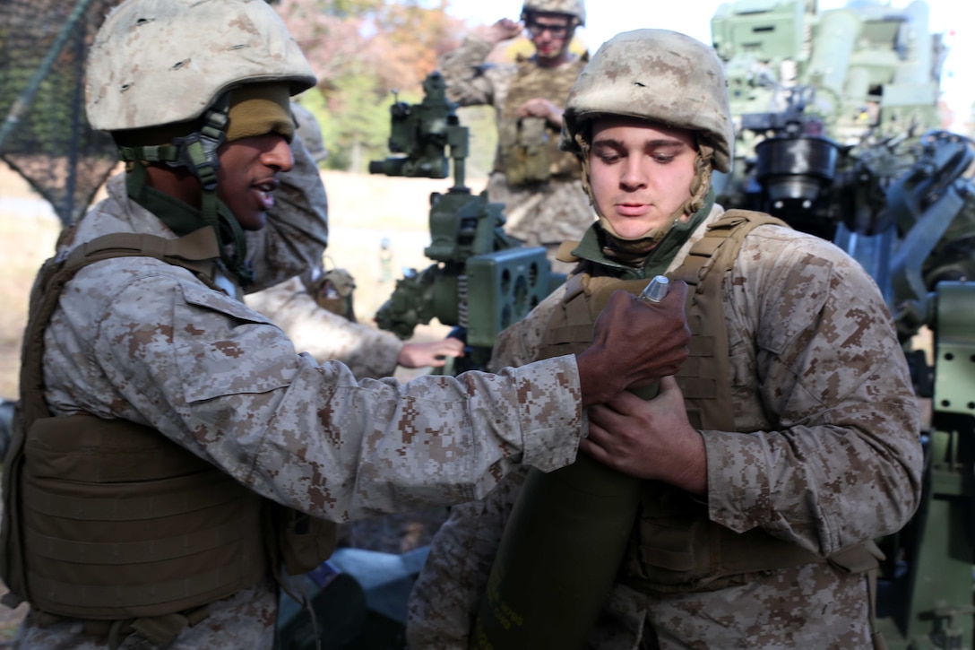 FORT INDIANTOWN GAP, Pa. - Lance Cpl. Wayne Rohall (right) a field artilleryman with India Battery, 3rd Battalion 14th Marine Regiment, 4th Marine Division, inspects ammunition with section chief Sgt. Julian E. Gomez III, before  loading a M777A2 Lightweight  Howitzer, Oct. 25, 2014 at Fort Indiantown Gap, Pa., during exercise Twisted Sister.  Exercise Twisted Sister was a live-fire artillery training exercise designed to hone tactics, techniques and procedures at the battalion level. (Marine Corps Photo by Cpl. J. Gage Karwick/Released)