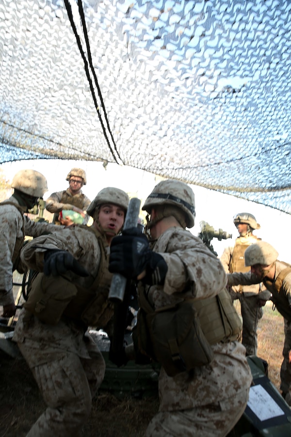 FORT INDIANTOWN GAP, Pa. - Lance Cpl. Wayne Rohall (Middle) and Lance Cpl. Steven Foster, field artillerymen with India Battery, 3rd Battalion 14th Marine Regiment, 4th Marine Division, ram a round into a M777A2 Lightweight Howitzer, Oct. 25, 2014 at Fort Indiantown Gap, Pa., during exercise Twisted Sister.  Exercise Twisted Sister was a live-fire artillery training exercise designed to hone tactics, techniques and procedures at the battalion level. (Marine Corps Photo by Cpl. J. Gage Karwick/Released)