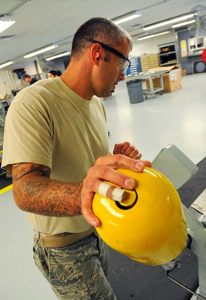 Staff Sgt. Jason Mayfield, 1st Special Operations Equipment Maintenance Squadron aircraft structural maintenance lead technician, uses a 90-degree grinder to bend sheet metal on Hurlburt Field, Fla., Oct. 29, 2014. Once the metal work is finished, the final product is used to repair MC-130P Combat Shadow. (U.S. Air Force photo/Airman 1st Class Andrea Posey)