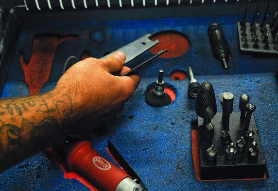 Staff Sgt. Robert McLendon, 1st Special Operations Equipment Maintenance Squadron aircraft structural maintainer, fixes a cracked stringer MC-130P Combat Shadow on Hurlburt Field, Fla., Oct. 29, 2014. A stringer reinforces the structure of an aircraft. (U.S. Air Force photo/Airman 1st Class Andrea Posey)