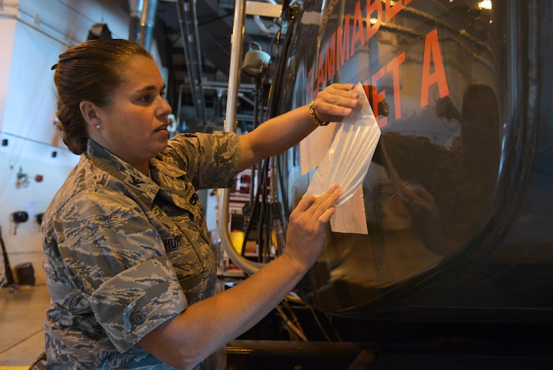 Col. Linda Hurry applies the Jet A1 fuel sticker on an R11 refueler as part of the conversion from JP8 fuel to Jet A1 fuel Oct. 15, 2014, Scott Air Force Base, Ill. Jet A1 fuel was created as a cost savings measure by the Department of Defense and will save approximately $40 million dollars annually. Hurry is the 635th Supply Chain Operations Wing commander. (U.S. Air Force photo/Tech Sgt. Christopher Boitz)