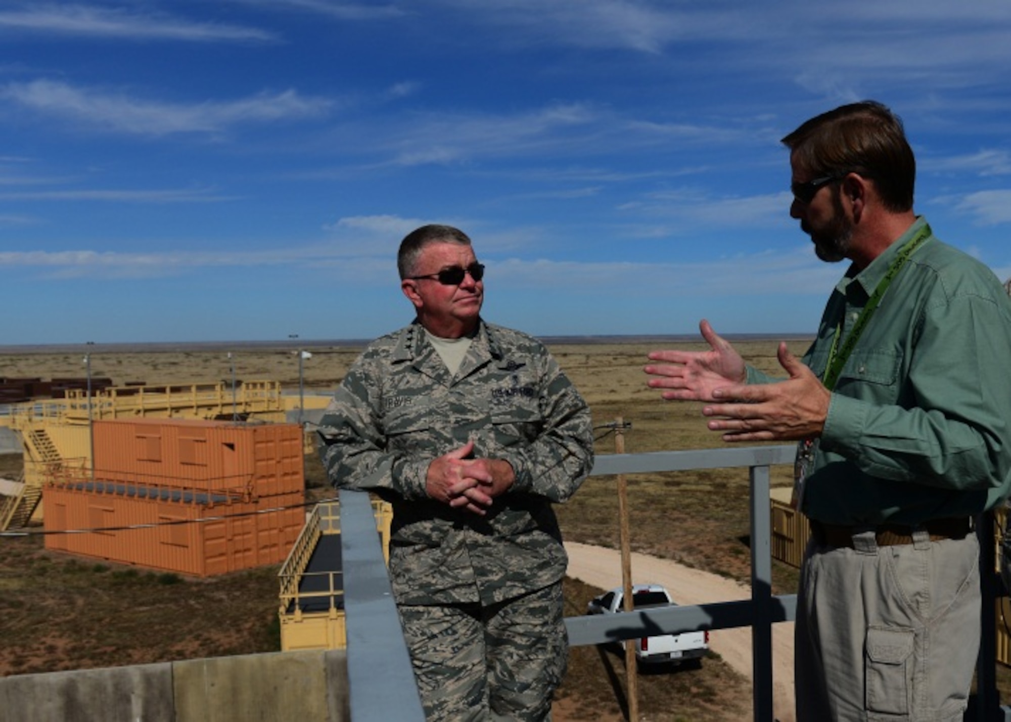 Steven Coffin, Melrose Air Force Range manager, briefs Lt. Gen. Thomas Travis, Surgeon General of the Air Force, on the assets that allow special operators from across the Department of Defense to practice Military Operations on Urban Terrain Oct. 28, 2014, at Melrose Air Force Range, N.M. This MOUT site provided a simulated urban combat environment to Cannon medics competing in the Commando Challenge during September's Emergency Medical Technicians rodeo. (U.S. Air Force Photo/Airman 1st Class Shelby Kay-Fantozzi)