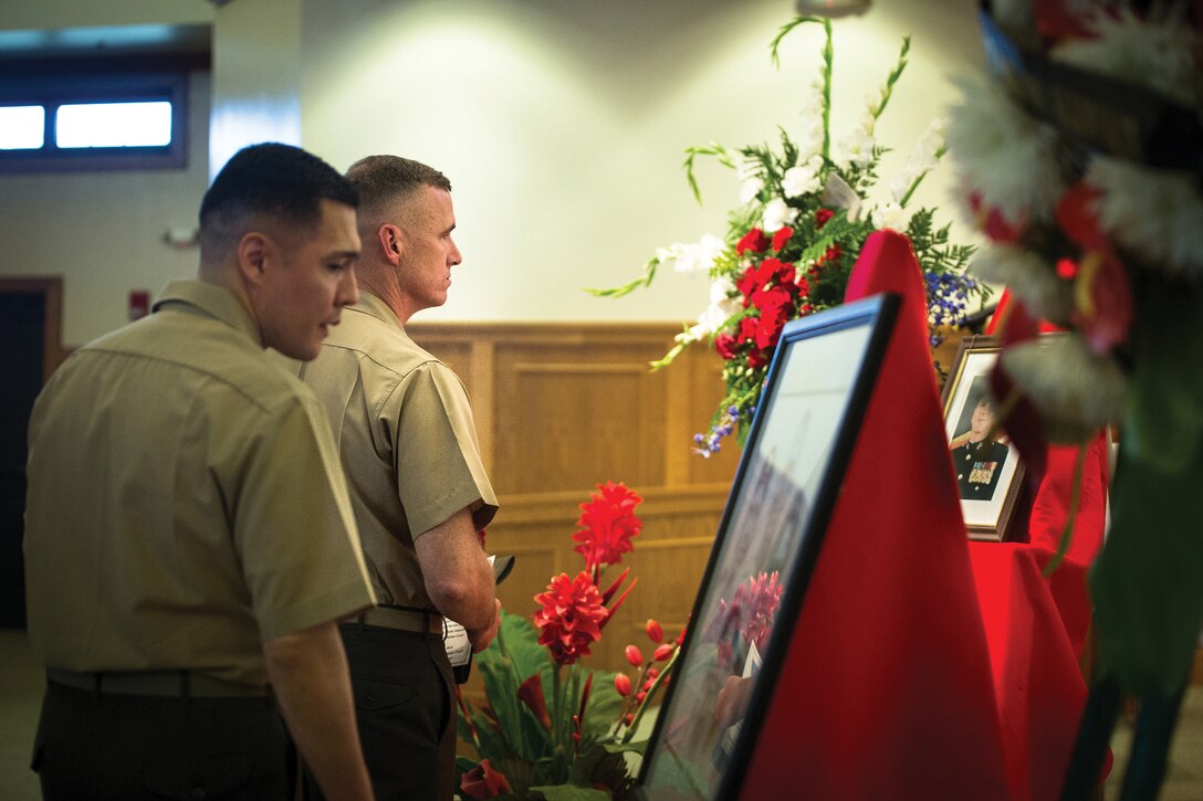 MARINE CORPS BASE HAWAII - Chief Warrant Officer 4 Carlos Tsapelas, Chemical, Biological, Radiological, Nuclear defense officer for U.S. Marine Corps Forces, Pacific, pays his final respects to Chief Warrant Officer 3 John “Jack” Johnson, who shares the same billet but is from a different unit, Oct. 24. Jack passed away Oct. 16. (U.S. Marine Corps photo by Lance Cpl. Brittney Vella)