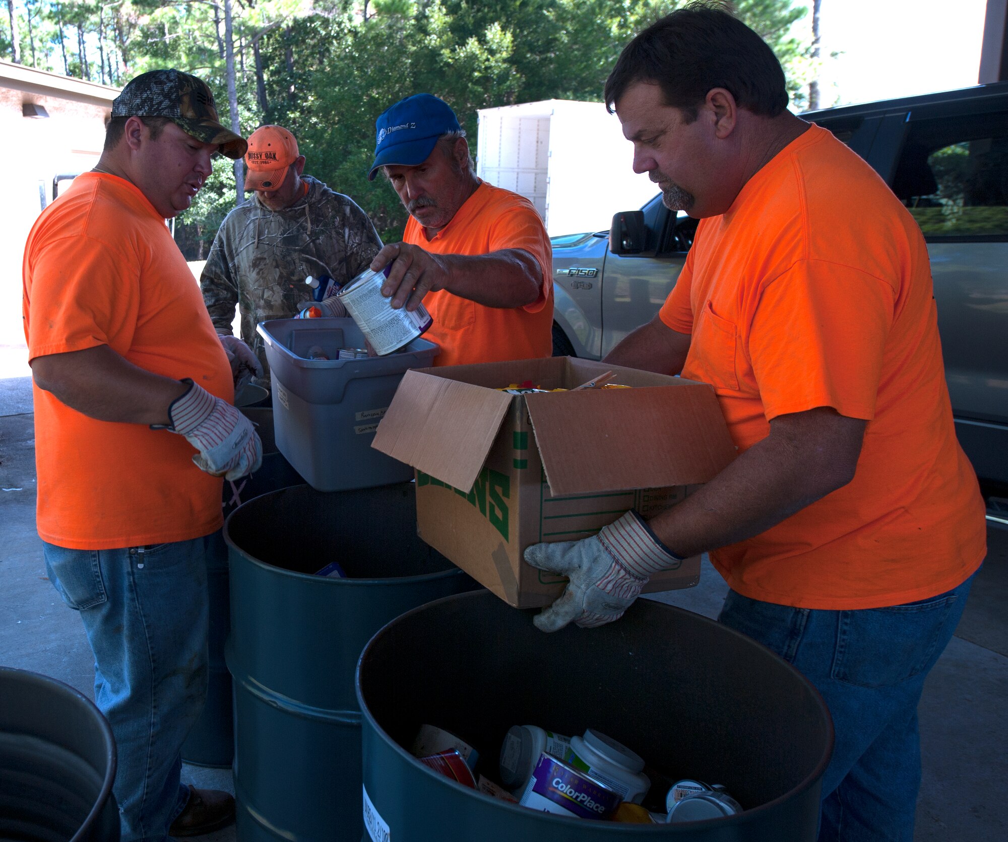 Okaloosa County Hazardous Waste workers sort recyclable household goods during a Household Hazardous Waste Collection Day at Hurlburt Field, Fla., Oct. 24, 2014. Tires, explosives and large appliances were not accepted at this event. (U.S. Air Force photo/Senior Airman Kentavist P. Brackin)
