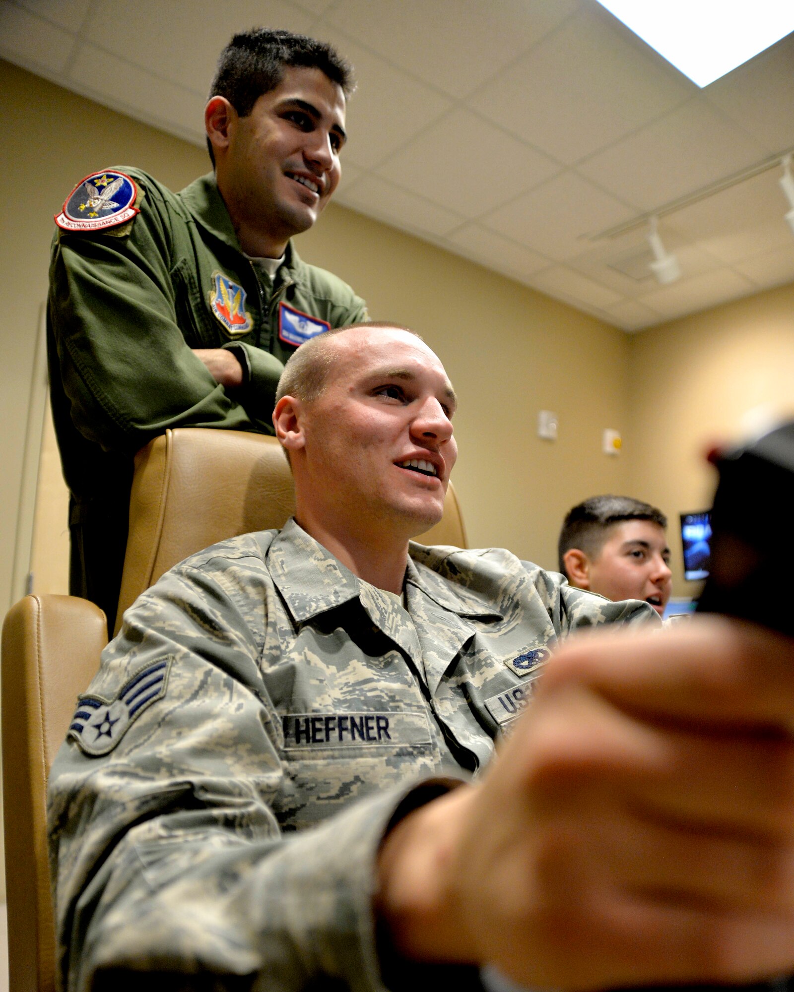 Senior Airman Zachary Heffner, 432nd Aircraft Maintenance Squadron Reaper avionics specialist, hits his target during a training mission in a Remotely Piloted Aircraft simulator Oct. 24, 2014, at Creech Air Force Base, Nevada. Maintenance members came to the flight simulators as part of an integration training program to build relationships between the maintenance and operations units. (U.S. Air Force photo by Staff Sgt. Adawn Kelsey/released some names have been withheld for security purposes)