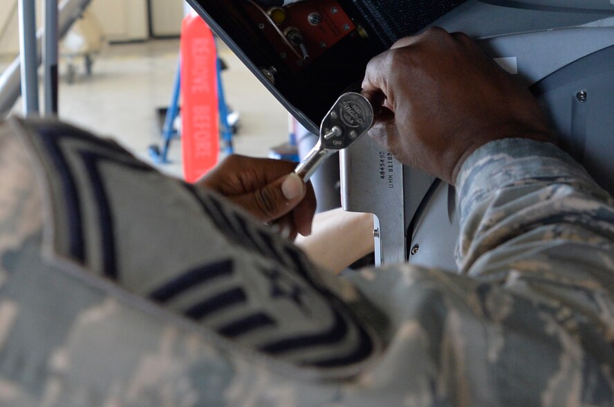 Senior Master Sgt. Roderick, 11th Reconnaissance Squadron squadron superintendent, tightens a bolt on the Multi-spectral Targeting System ball, during operations and maintenance integration training Oct. 22, 2014, at Creech Air Force Base, Nevada. Members from the 11th RS teamed up with members of the 432nd Aircraft Maintenance Squadron to build an MQ-9 Reaper as part of an effort to help the different units understand each other’s side of the mission requirements. (U.S. Air Force photo by Staff Sgt. Adawn Kelsey/released some names have been withheld for security purposes)