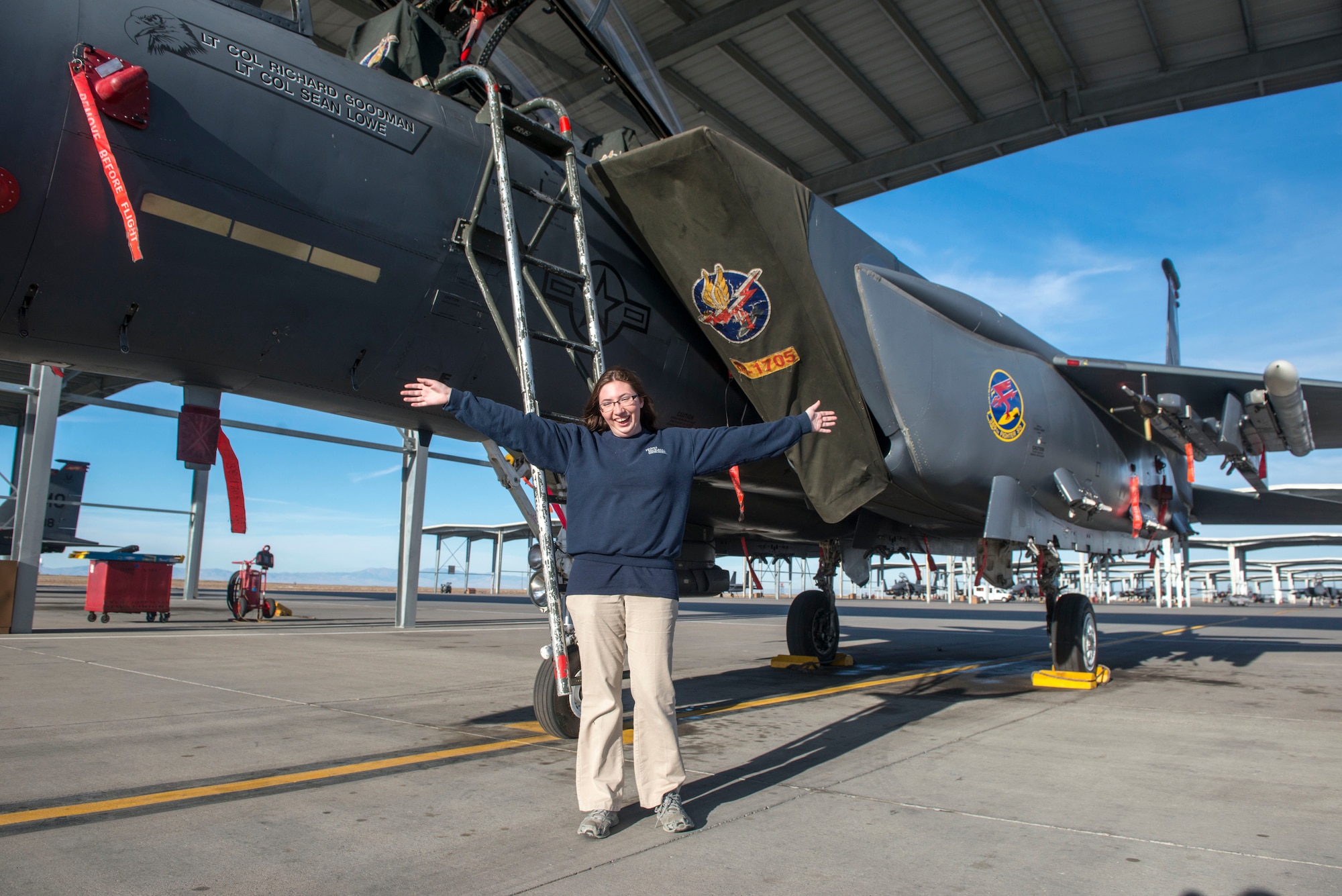 Brighid McMullen, Richard McKenna Charter High School student, poses in front of an F-15E Strike Eagle at Mountain Home Air Force Base, Idaho, Oct. 30, 2014. Her father worked on similar flightlines as an ammunitions crew member during his years of service. (U.S. Air Force photo by Airman Connor J. Marth/RELEASED)  
