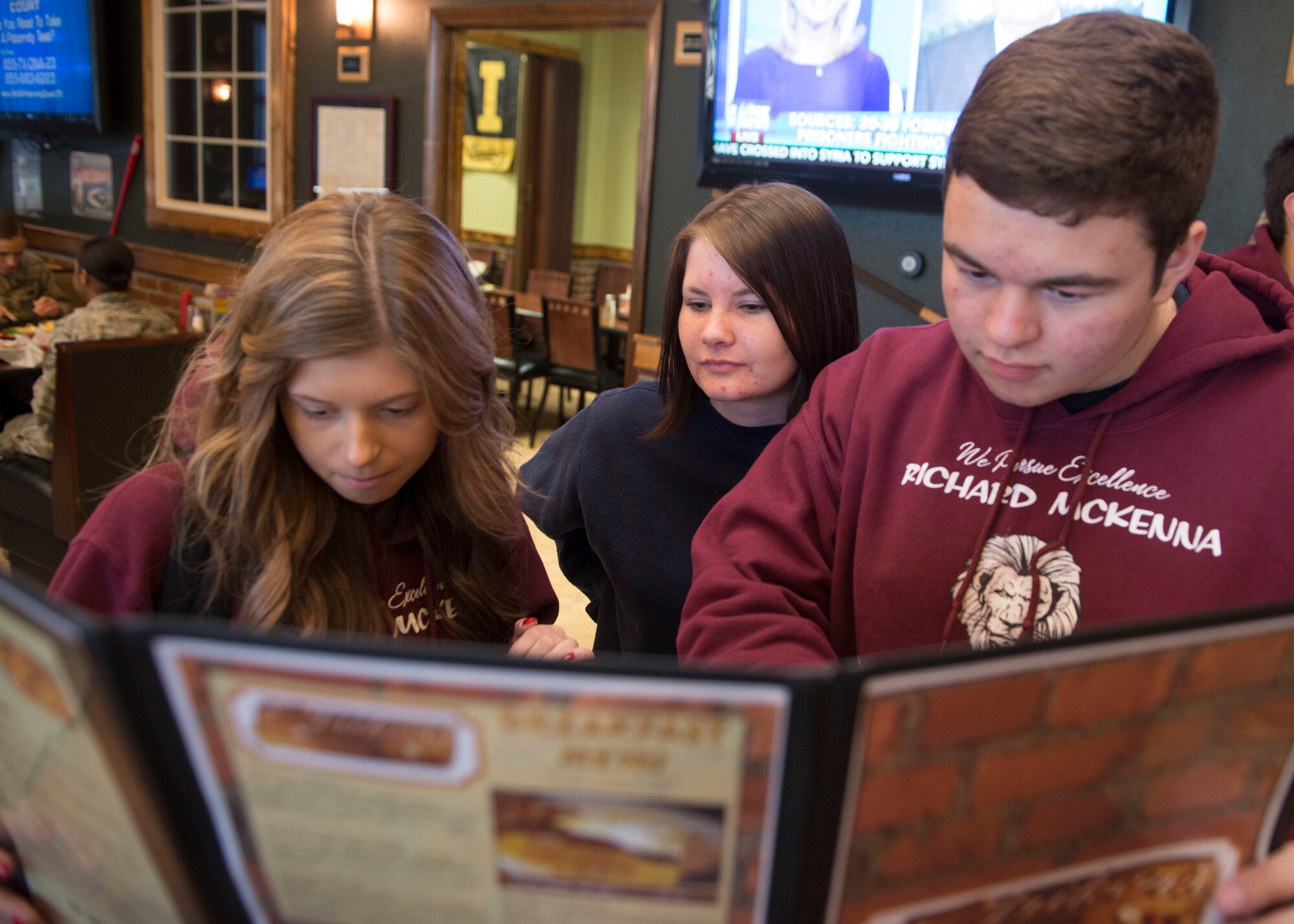 Richard McKenna Charter High School students look over a Strikers Grill menu at Mountain Home Air Force Base, Idaho, Oct. 30, 2014. The students wrapped up a day visiting base with a meal at the grill. (U.S. Air Force photo by Airman Connor J. Marth/RELEASED)  
