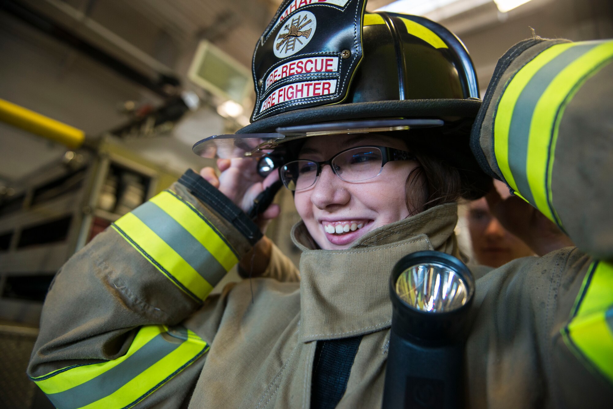 Brighid McMullen, Richard McKenna Charter High School student, gets dressed in fire gear to see what it’s like to be an Air Force firefighter at Mountain Home Air Force Base, Idaho, Oct. 30, 2014. Students visited the base to experience the day-to-day lives of Airmen. (U.S. Air Force photo by Airman Connor J. Marth/RELEASED)  