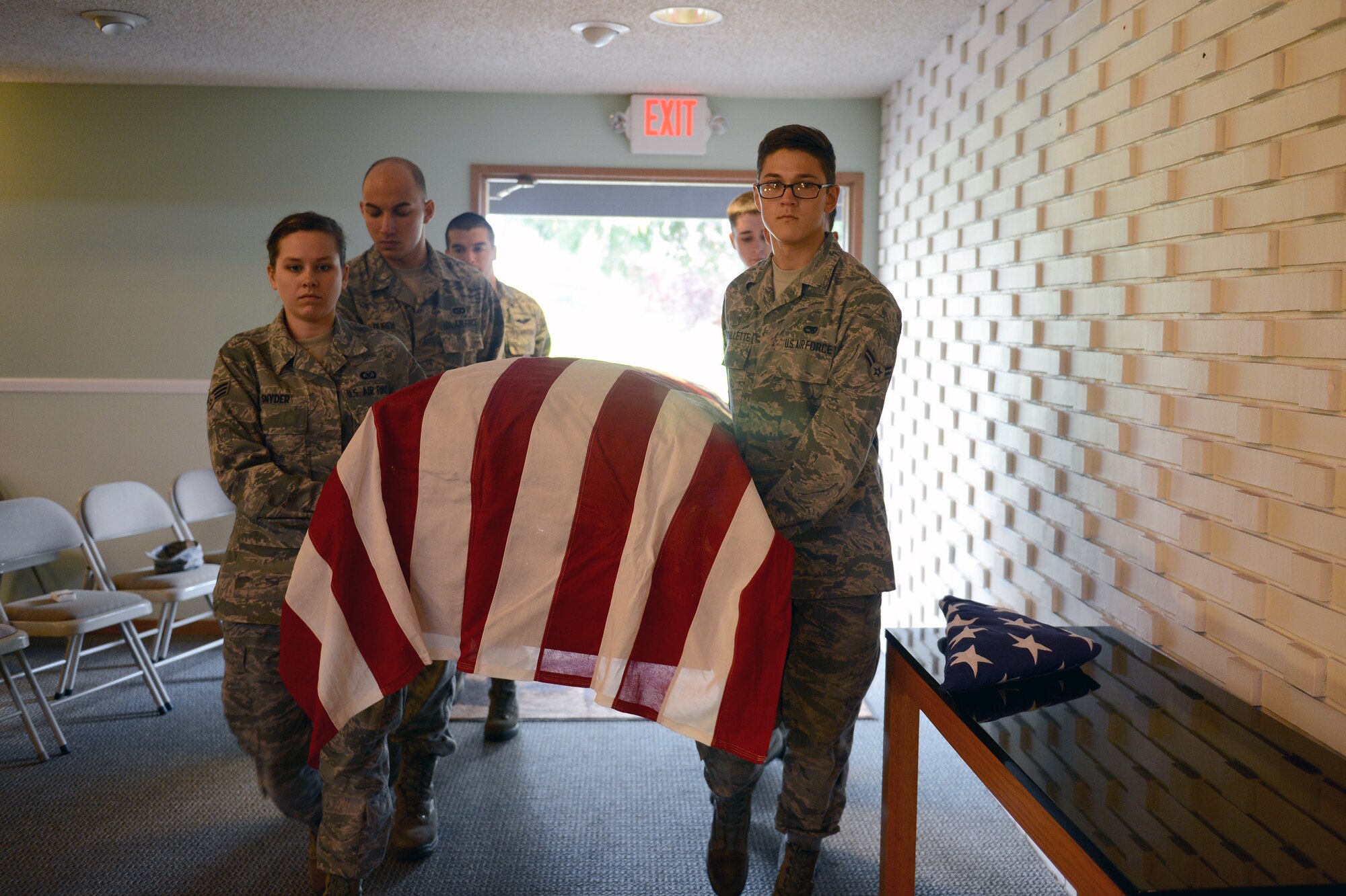 McChord Field Honor Guard members carry an empty casket to the church truck Oct. 29, 2014, during a practice funeral in Tacoma, Wash. Honor guard members train five days a week to practice and perfect their movements and receive numerous scenarios, such as the hearse driving the opposite way, to help them resolve any problems they come across in future details. (U.S. Air Force photo/Airman 1st Class Keoni Chavarria)