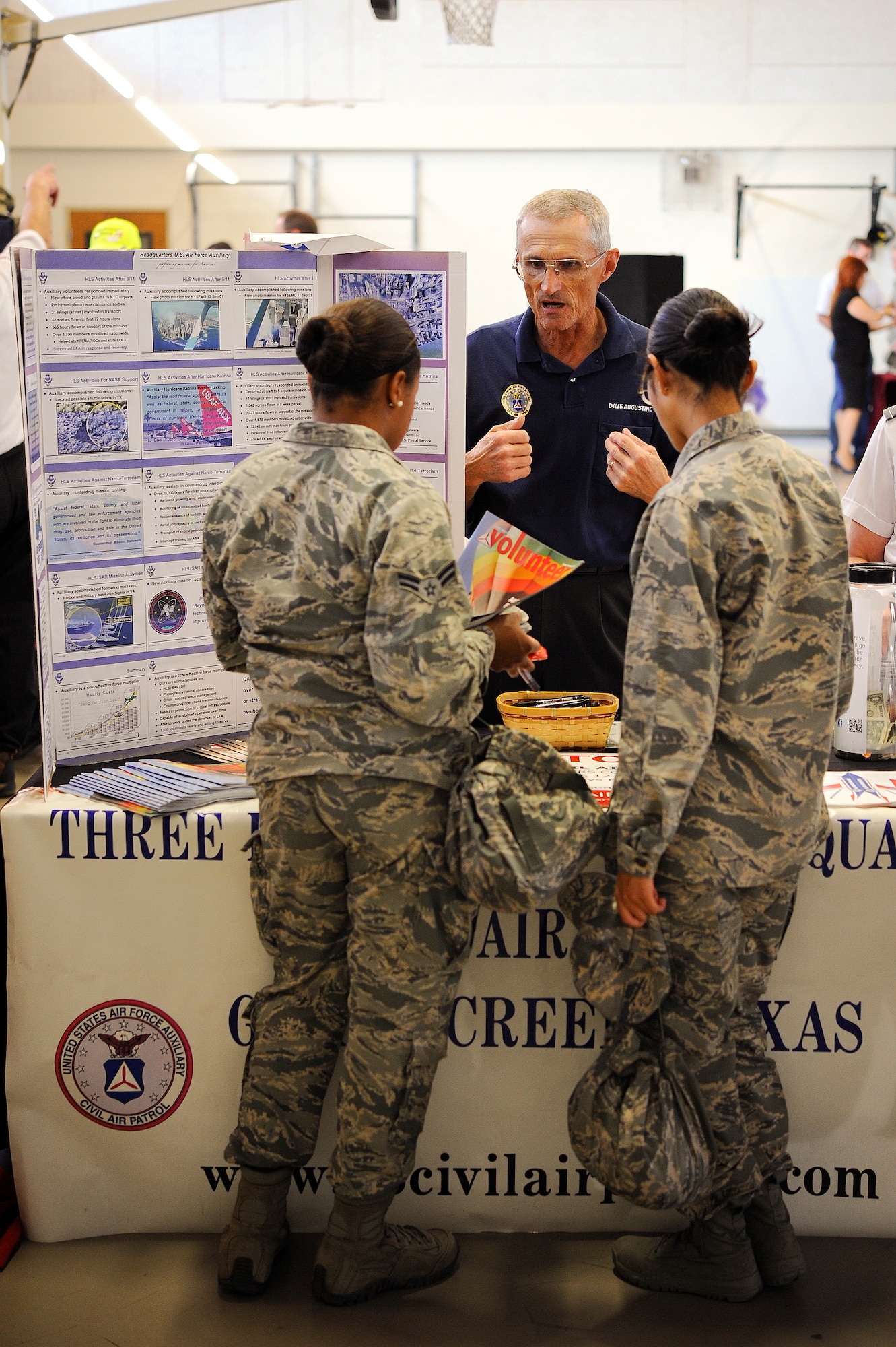 GOODFELLOW AIR FORCE BASE, Texas – Dave Augustine, Civil Air Patrol representative, discusses volunteer opportunities with Goodfellow Airmen during the Volunteer Fair at the Carswell Field House Oct. 30. The Volunteer Fair is a biannual event that brings in nonprofit organizations from the community to share their missions and seek volunteers. (U.S. Air force photo/ Airman 1st Class Devin Boyer)