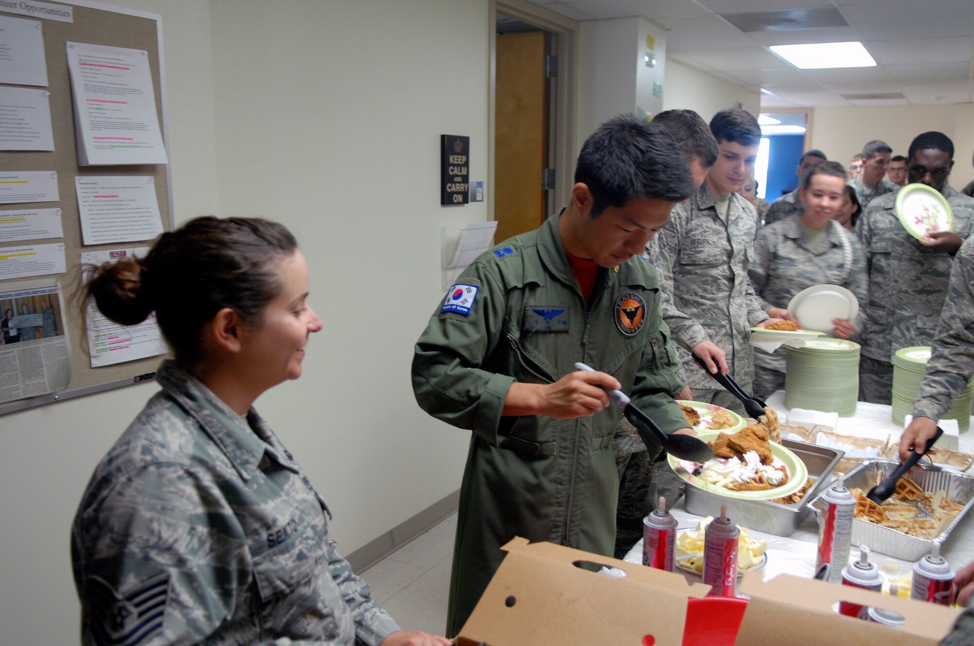 GOODFELLOW AIR FORCE BASE, Texas – Maj. Wanjoo Lim, Republic of Korea, loads up his plate during the Waffle ra-IDS event at Crossroads Student Center hosted by the 17th Training Wing Taylor Chapel staff Oct. 28.  The free lunch was the second event of Wingman Week.  (U.S. Air Force photo/1st Lt. Nathaniel Roesler)