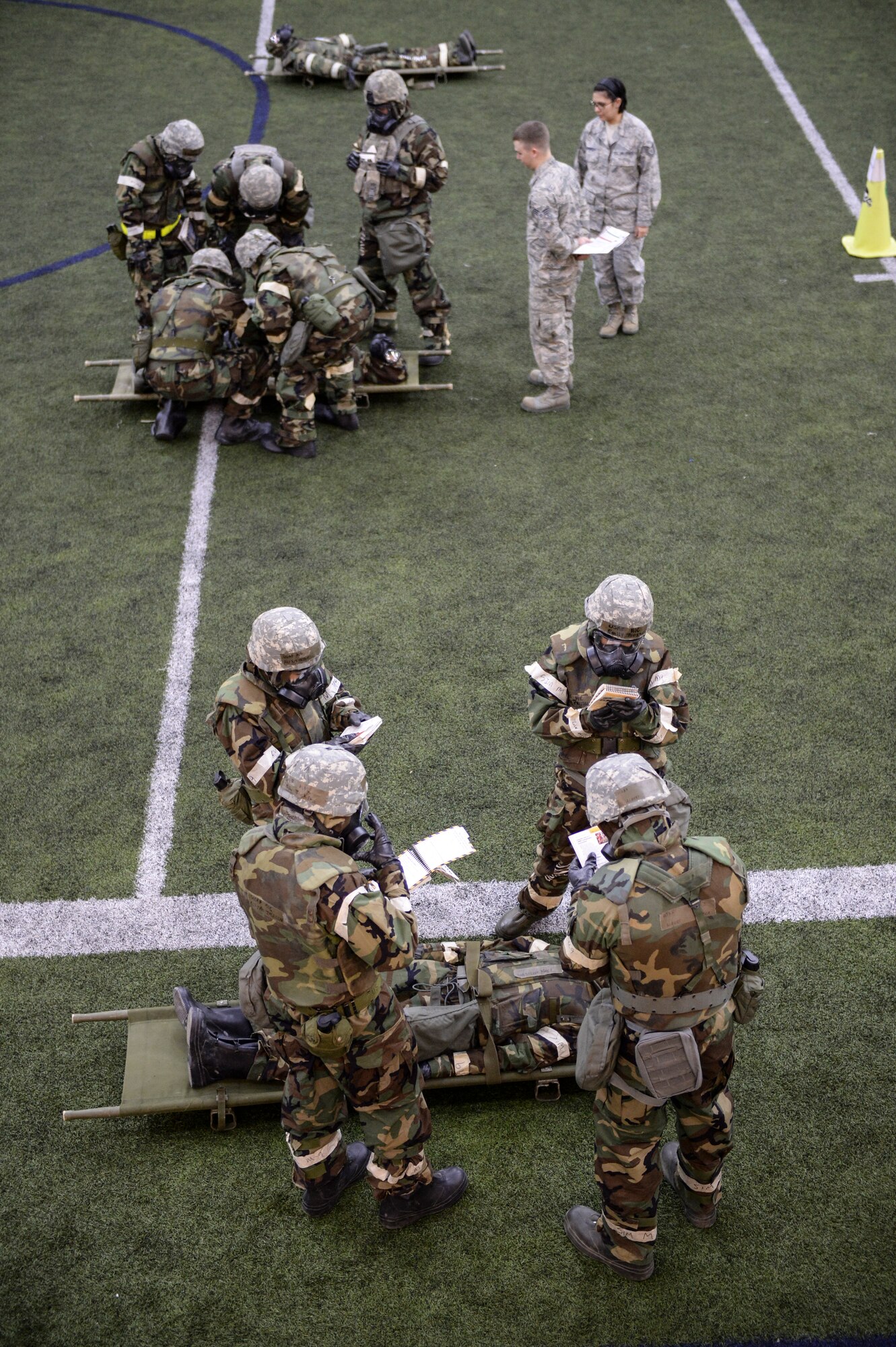 U.S. Airmen practice self-aid and buddy care (SABC) techniques after a simulated chemical attack Oct. 28, 2014, during ability to survive and operate (ATSO) training at Eielson Air Force Base, Alaska. The ATSO training tested Airmen with various emergency situations including chemical attack, unexploded ordnance and SABC. (U.S. Air Force photo by Senior Airman Peter Reft/Released)