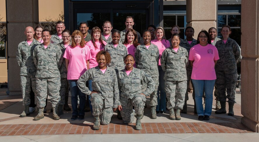 Members of the 7th Medical Group show off their pink morale shirts Oct. 24, 2014, at Dyess Air Force Base, Texas. Members of all three squadrons within the 7th Medical Group wore pink morale shirts every Friday throughout the month of October to remind patients to schedule their mammogram screenings. (U.S. Air Force photo by Senior Airman Shannon Hall/Released)