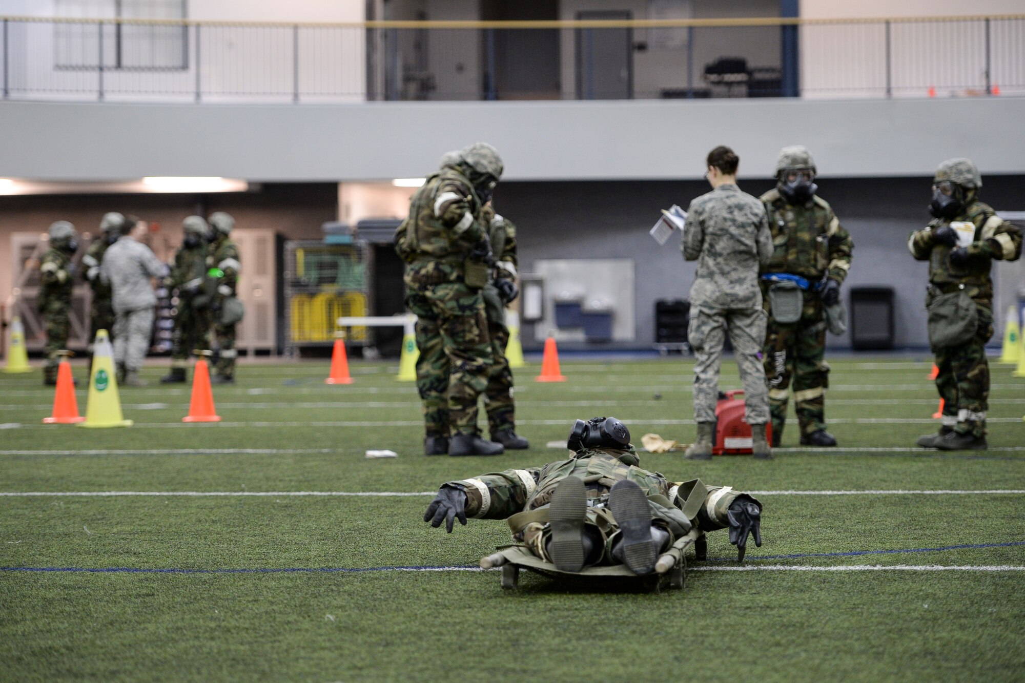U.S. Airmen walk through various emergency response procedures Oct. 28, 2014, during ability to survive and operate (ATSO) training at Eielson Air Force Base, Alaska. A new streamlined process of training enabled ATSO cadres to efficiently handle large numbers of Airmen and kept training down time to a minimum. (U.S. Air Force photo by Senior Airman Peter Reft/Released)