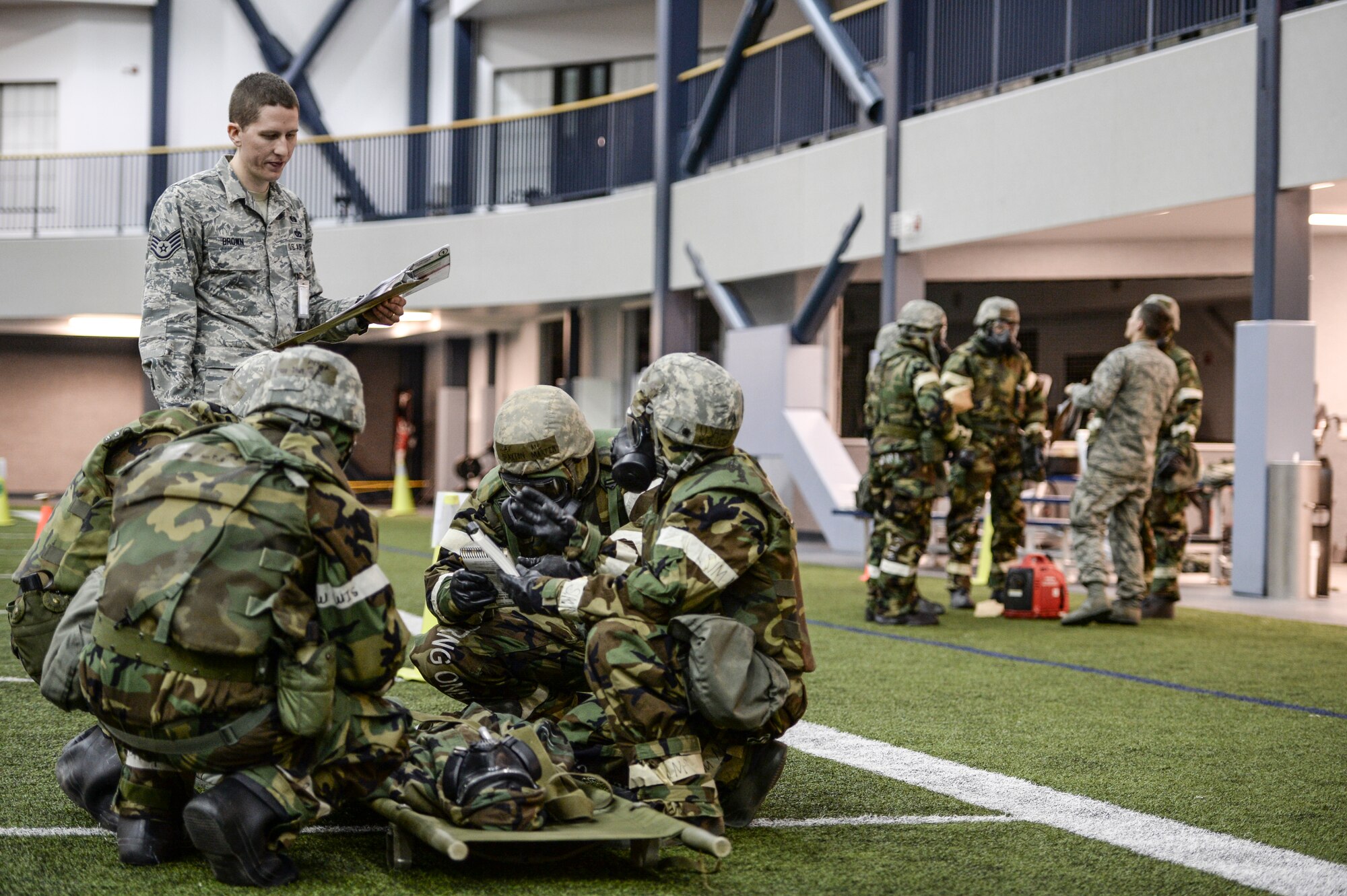 U.S. Airmen run through simulated phases of chemical attack and handling casualties Oct. 28, 2014, during ability to survive and operate (ATSO) training at Eielson Air Force Base, Alaska. The ATSO training tested Airmen with various emergency situations including chemical attack, unexploded ordnance and self-aid and buddy care. (U.S. Air Force photo by Senior Airman Peter Reft/Released)