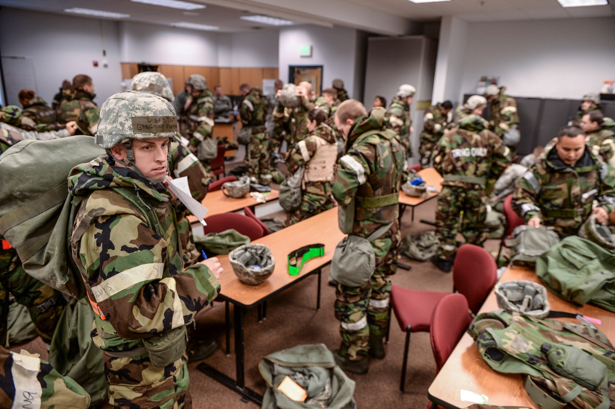 U.S. Airmen don mission-oriented protective posture gear Oct. 28, 2014, during ability to survive and operate (ATSO) training  at Eielson Air Force Base, Alaska. The ATSO training tested Airmen with various emergency situations including chemical attack, unexploded ordnance and self-aid and buddy care. (U.S. Air Force photo by Senior Airman Peter Reft/Released)